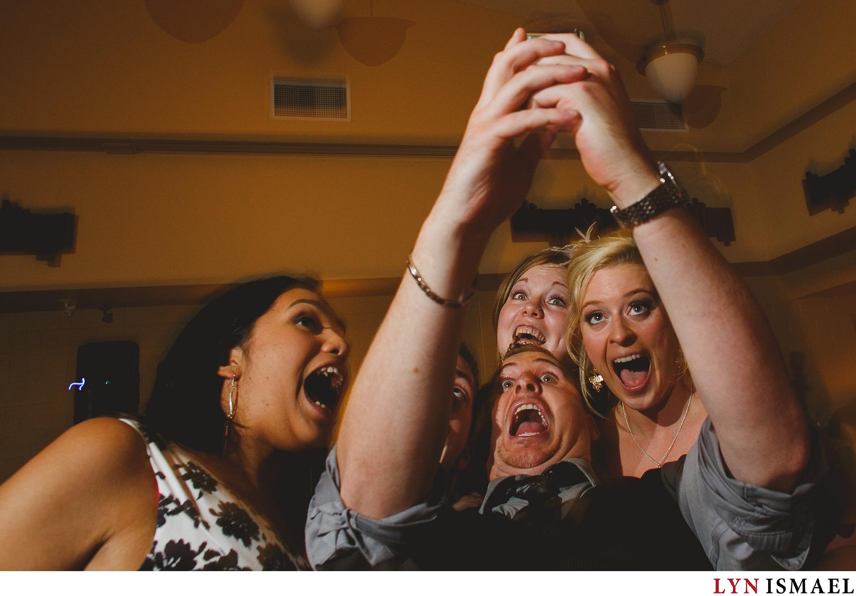 Wedding guests post for a selfie at a Stoney Creek wedding reception.
