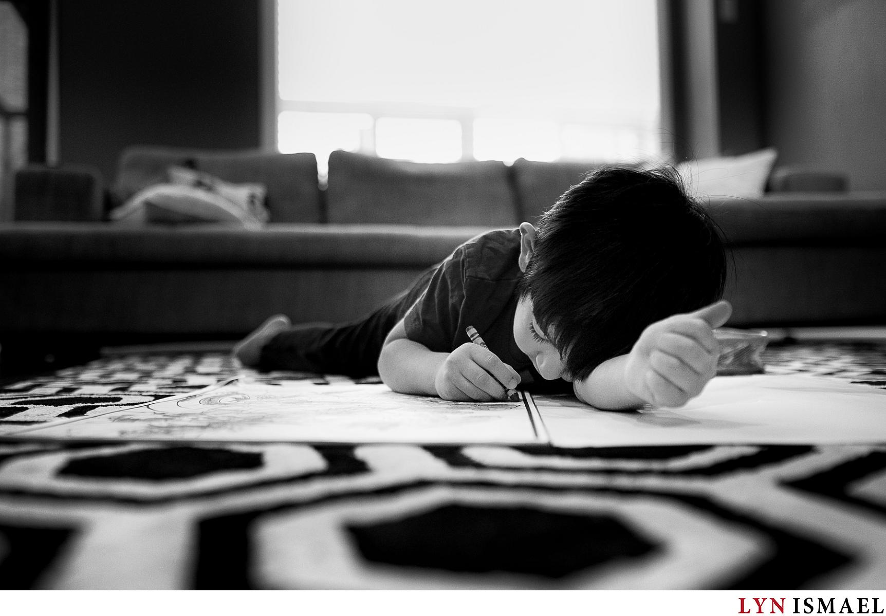 Little boy concentrating on his colouring book