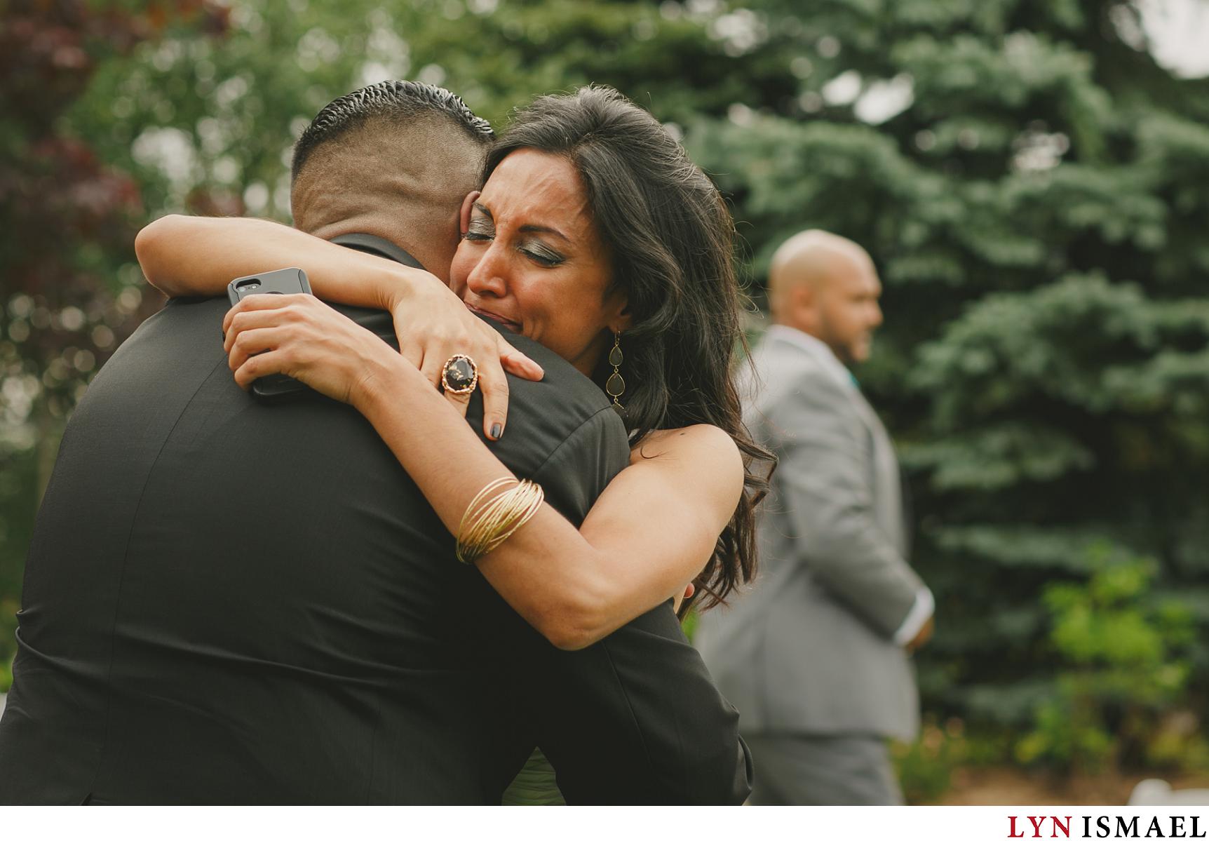 groom's sister hugs her bother