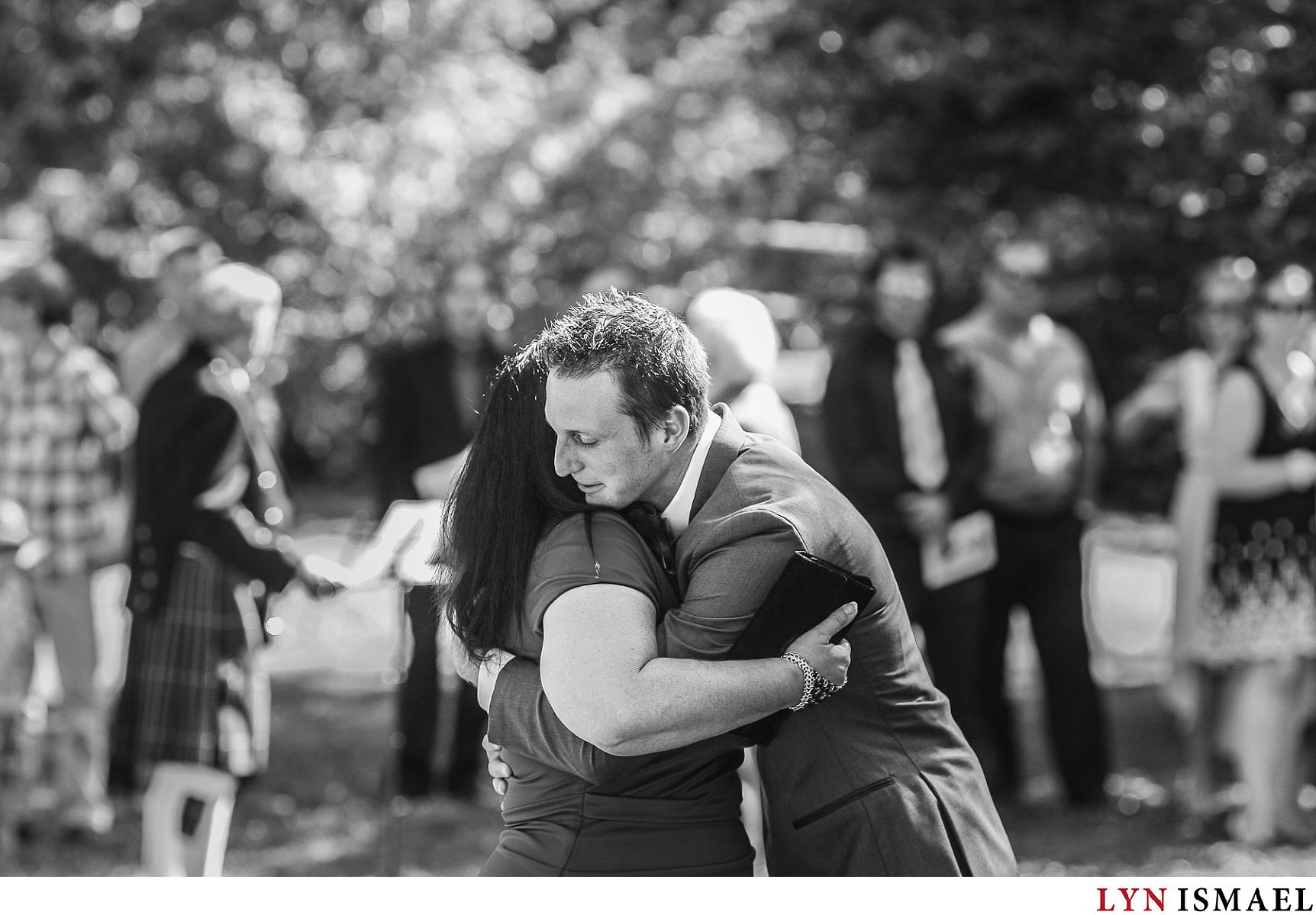 Groom hugs his mother at his wedding ceremony in Elora, Ontario.