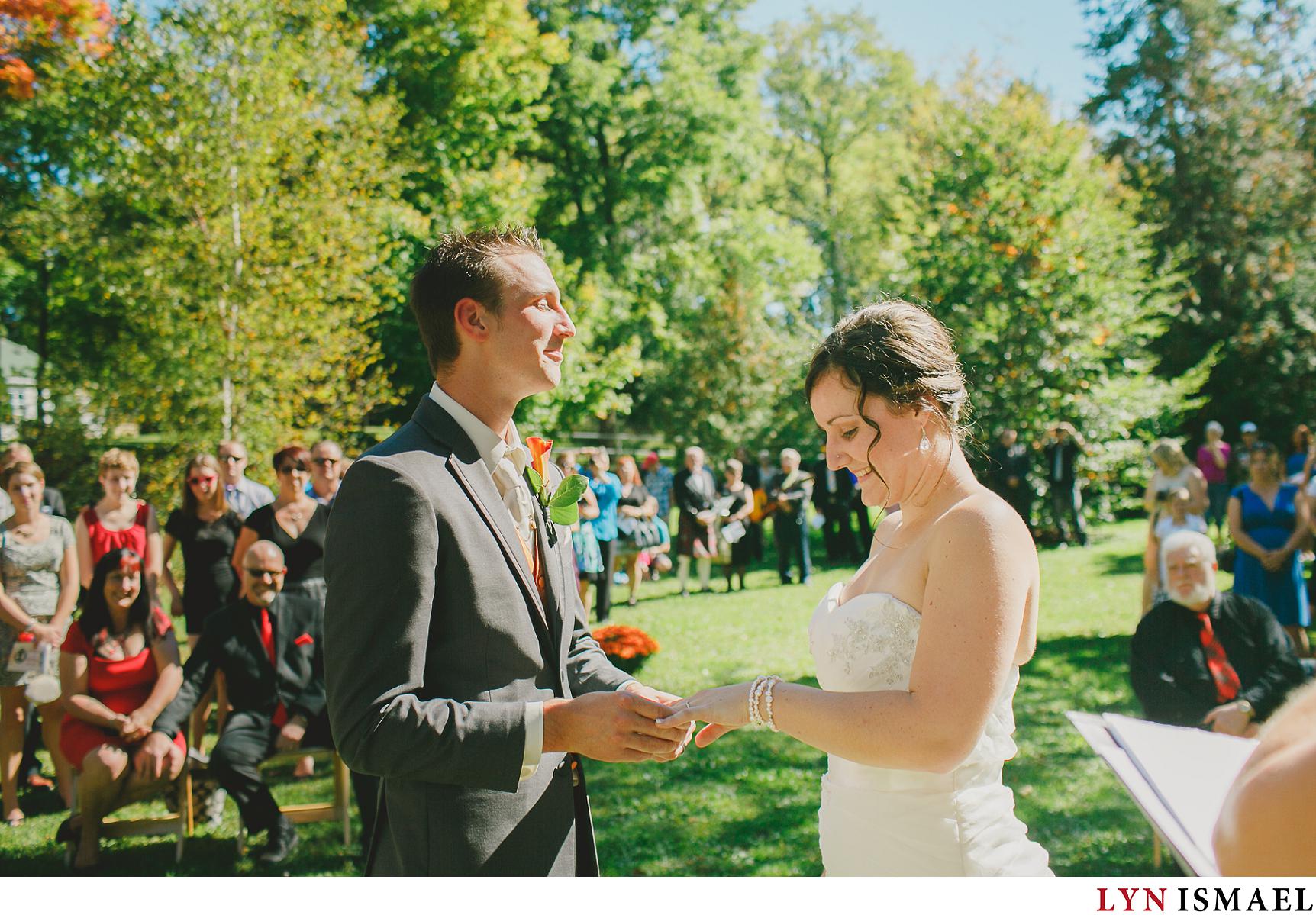 The exchange of rings photographed at an outdoor wedding by Elora wedding photographer