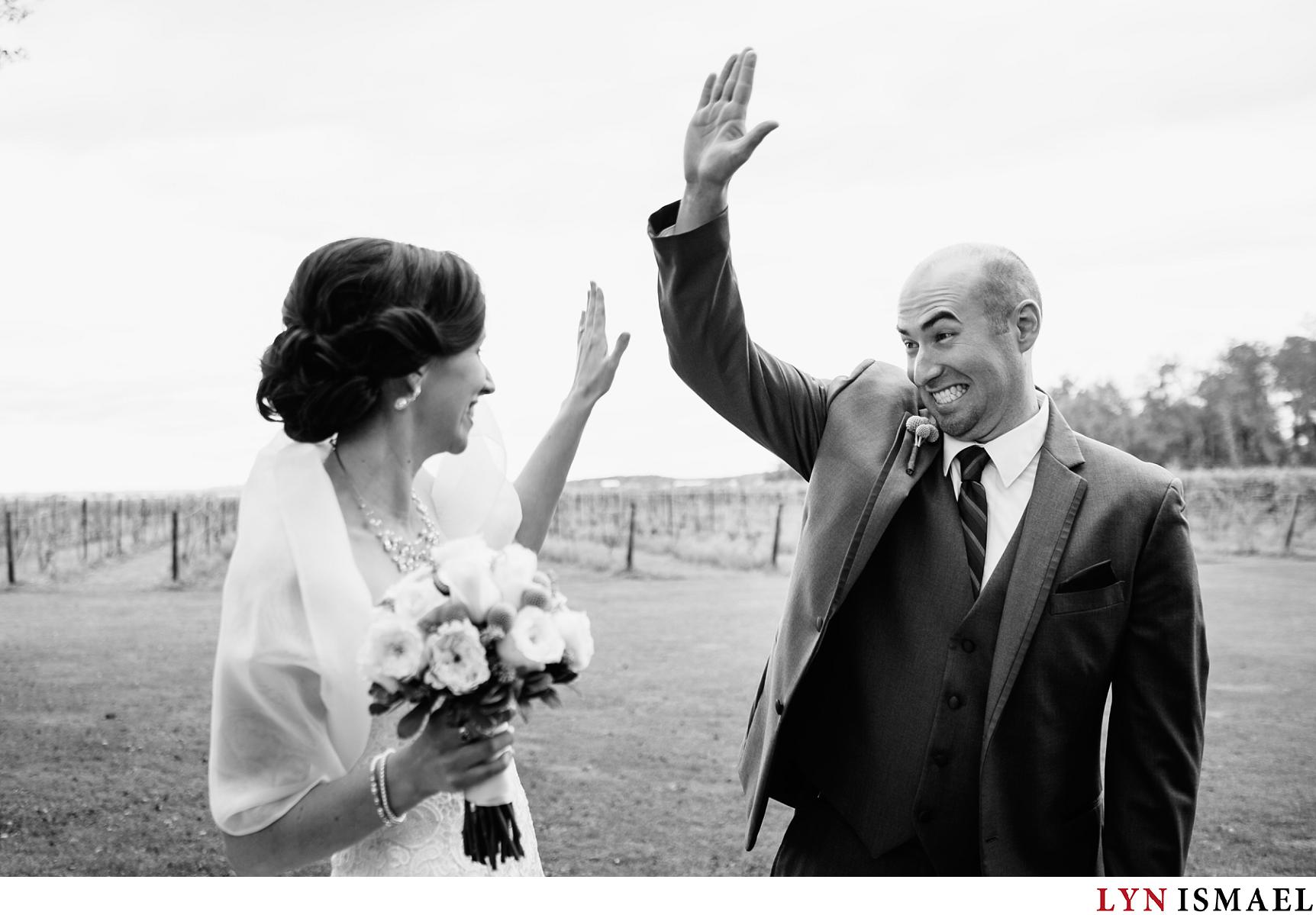 Bride and groom give each other a high five.