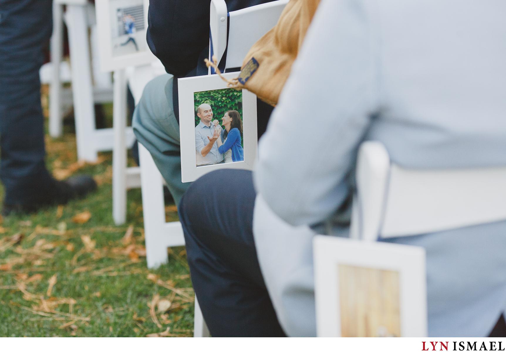 Simple white frames featuring the couple's engagement photos line up the aisle.