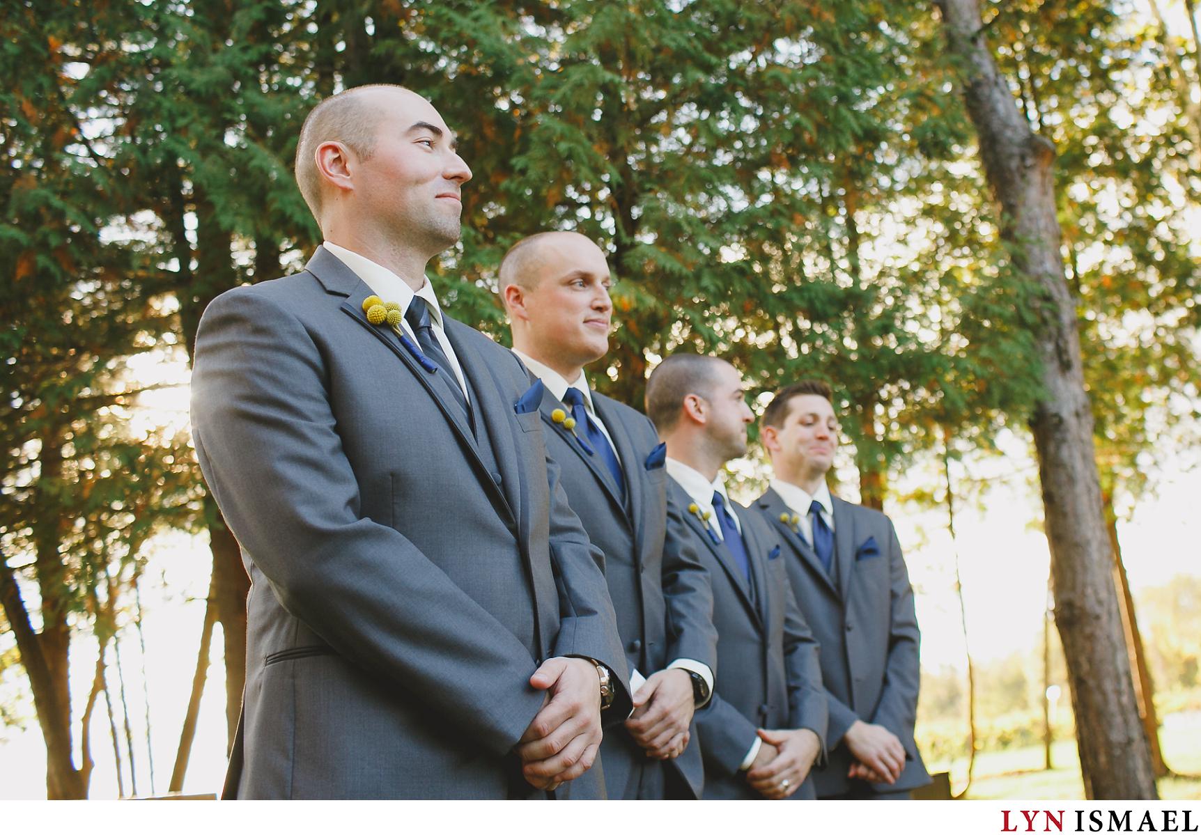Groom waits for his bride to walk down the aisle at their Holland Marsh Wineries wedding.