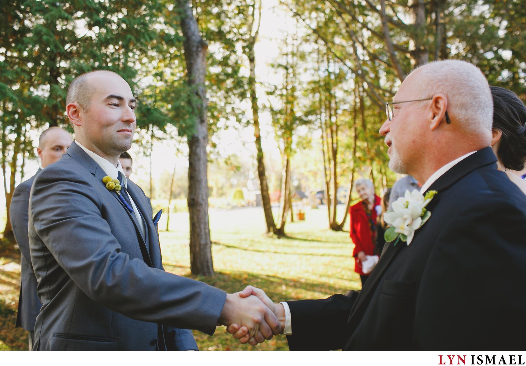Groom and father of the bride shakes hands