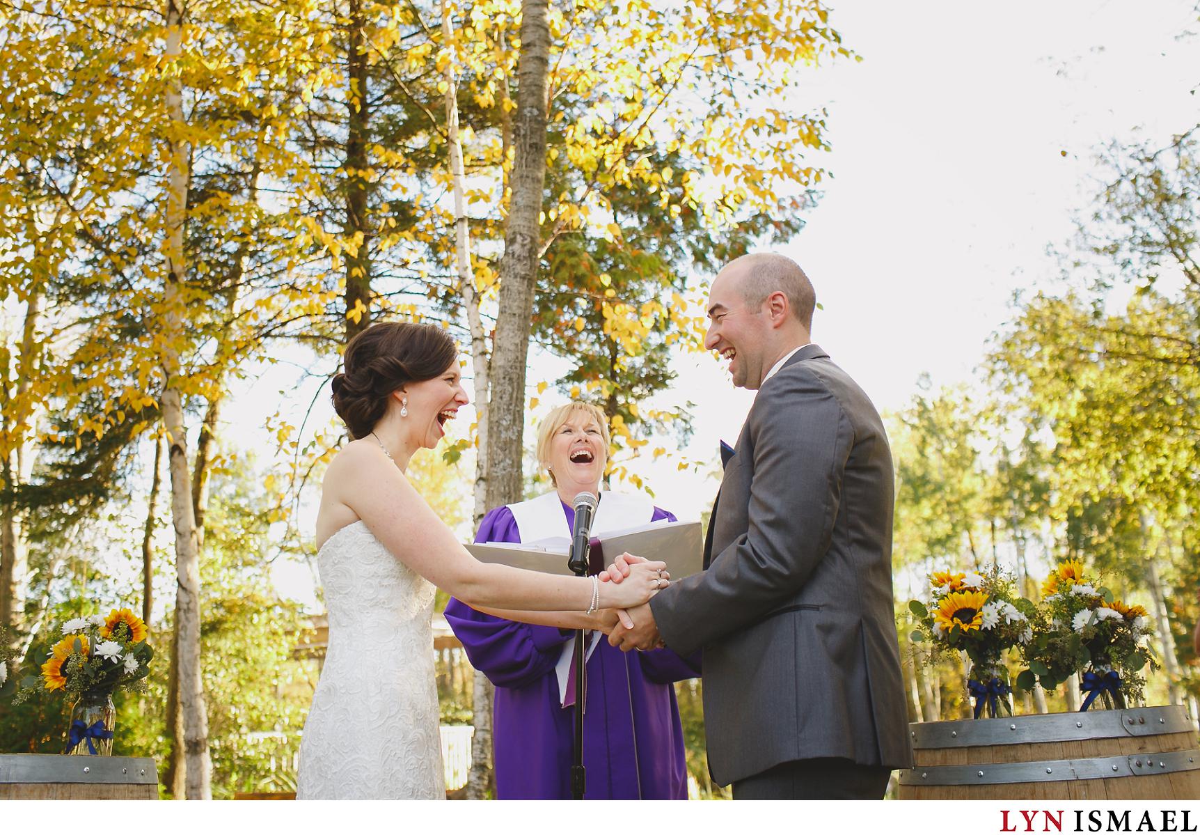 Bride and groom laughs during their wedding reception