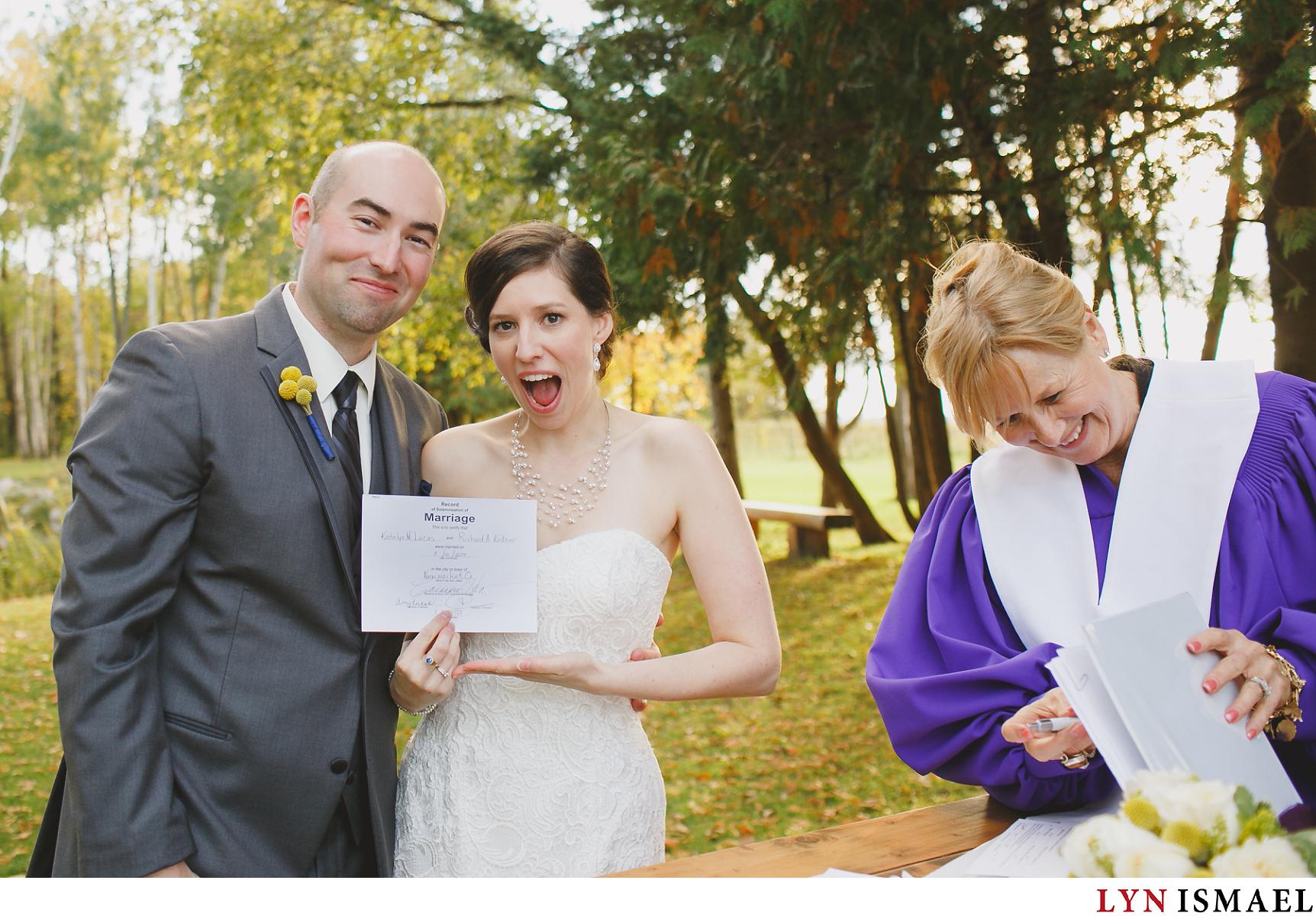 Bride displays their marriage certificate to their Holland Marsh wedding photographer.