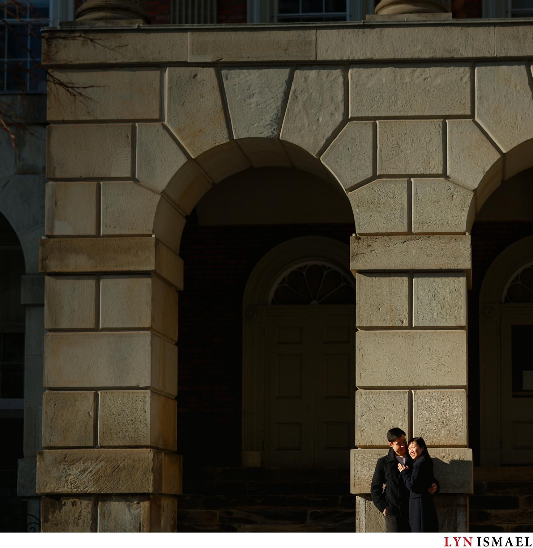 Arches at Osgoode Hall beside Nathan Phillips Square provided a dramatic background for a couple's engagement session in Toronto, Ontario.
