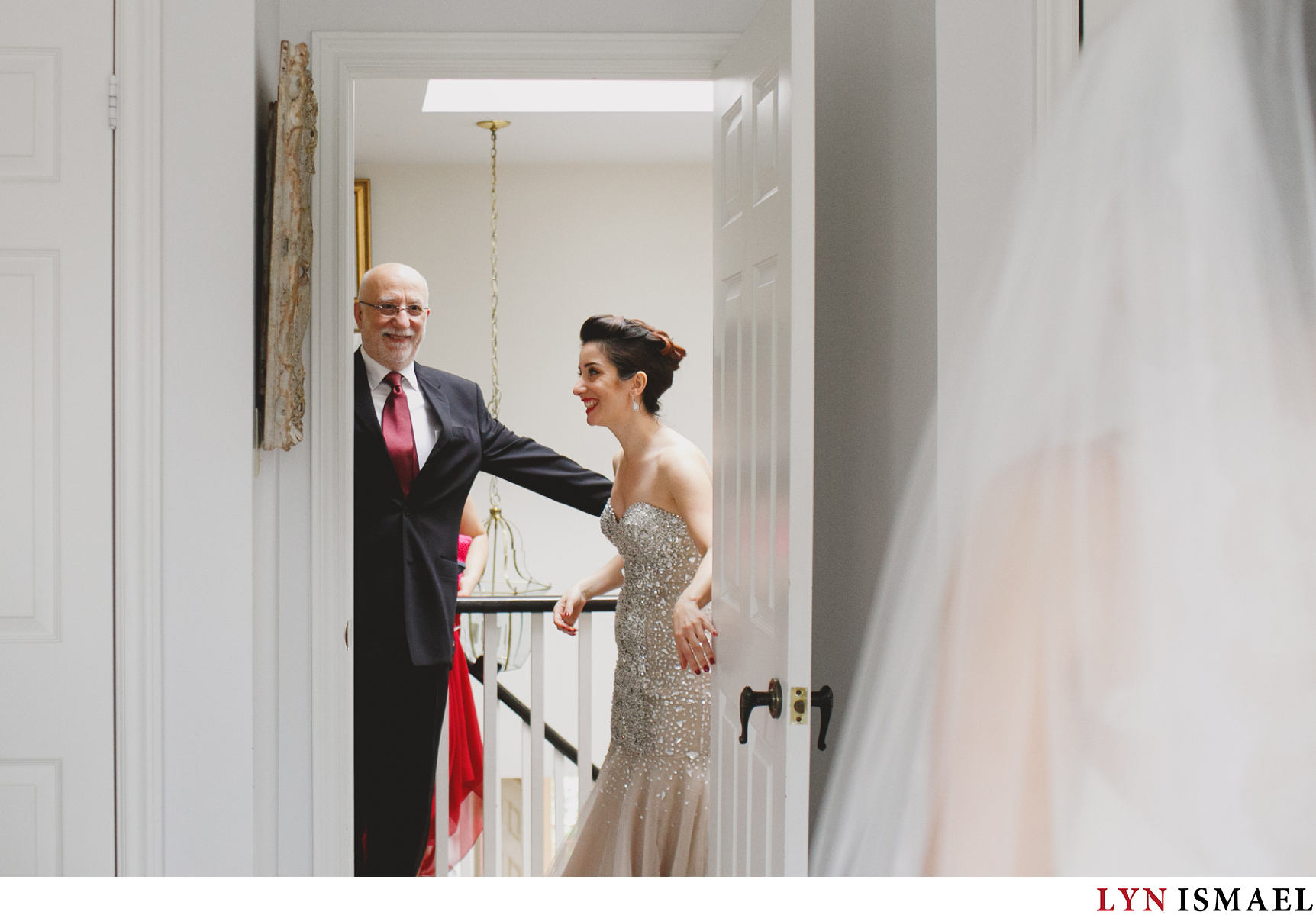 Father of the bride sees his daughter for the first time dressed up like a bride.