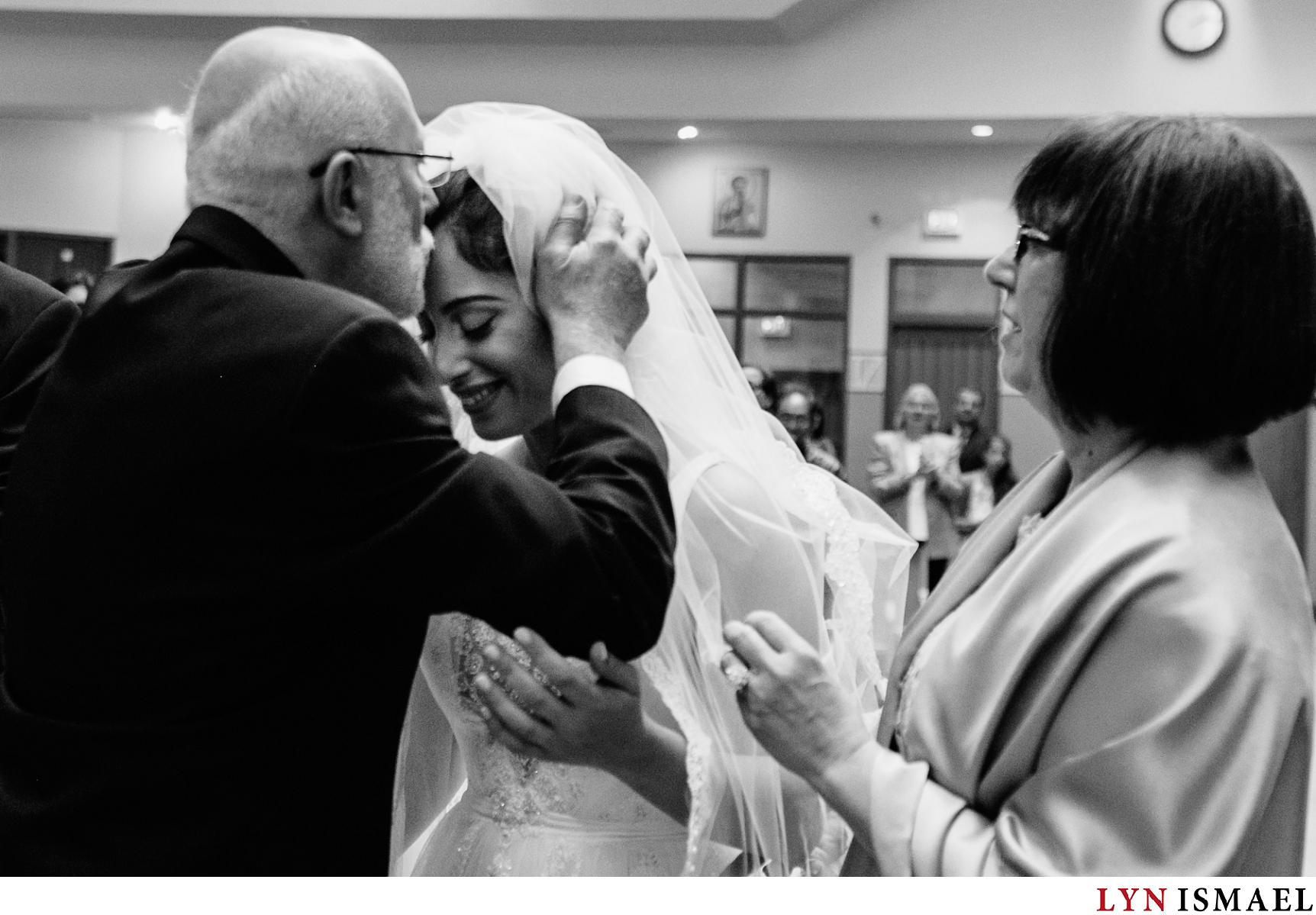 Father of the bride kisses the bride's forehead as he gave her away.