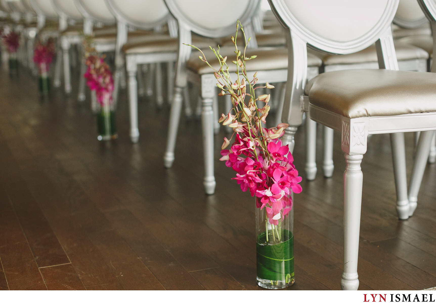 Pink orchids at a wedding ceremony held at the Rose Room in Whistle Bear Golf Club
