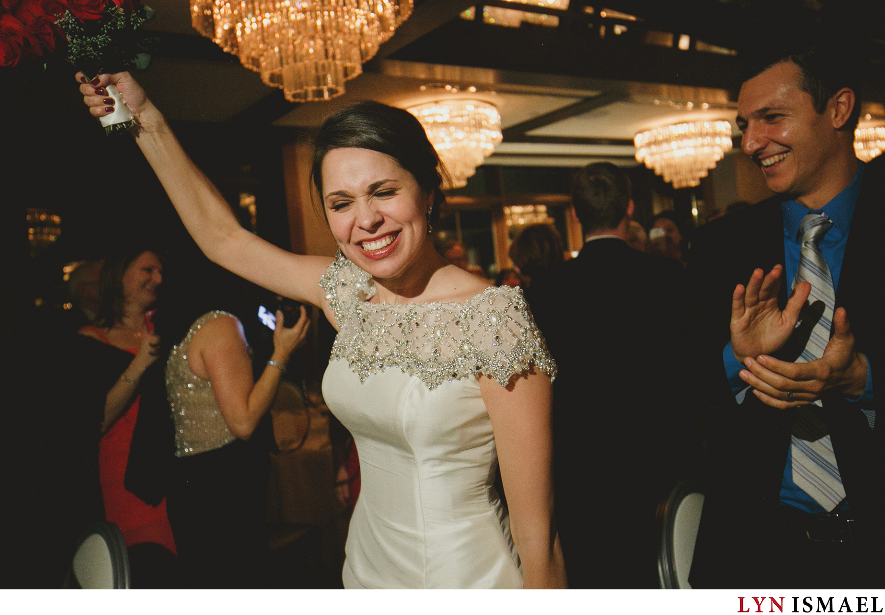 The bride enters Grandview Room at Whistle Bear Golf Club as their wedding guests cheered on.