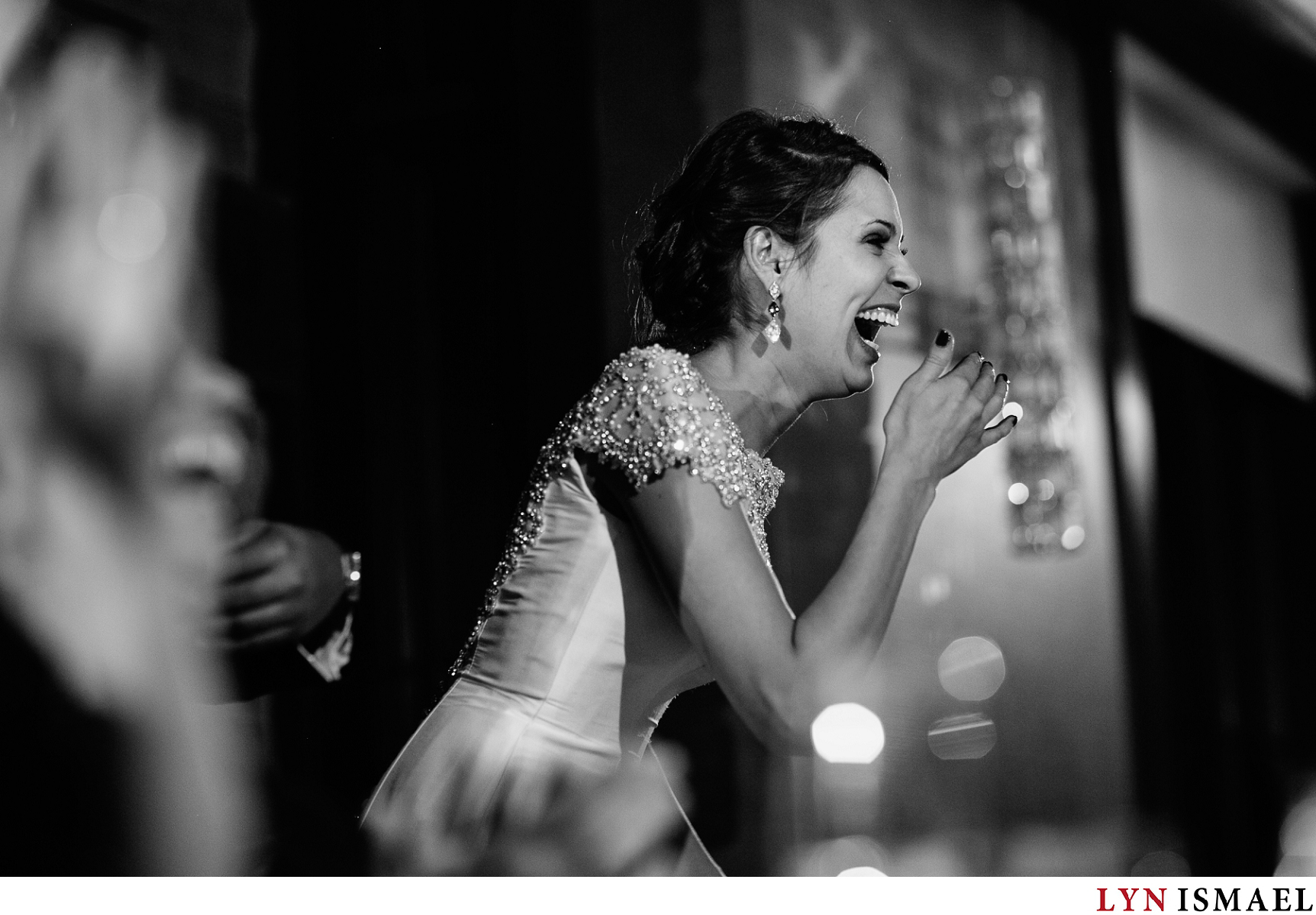 A happy bride reacts to a slideshow her friends put together for her and her new husband at their wedding reception at the Grandview Room of Whistle Bear Golf Club in Cambridge, Ontario.