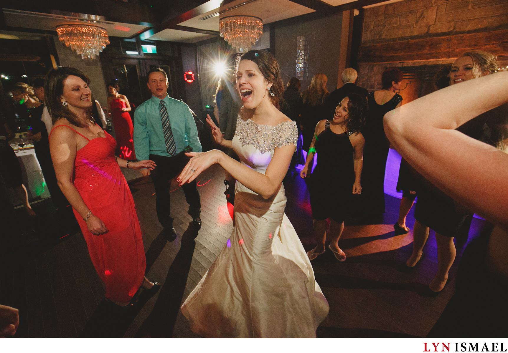 A very happy bride shows off her dance moves while her wedding guests encircle her at Whistle Bear Golf Club's Grandview Room dancefloor.