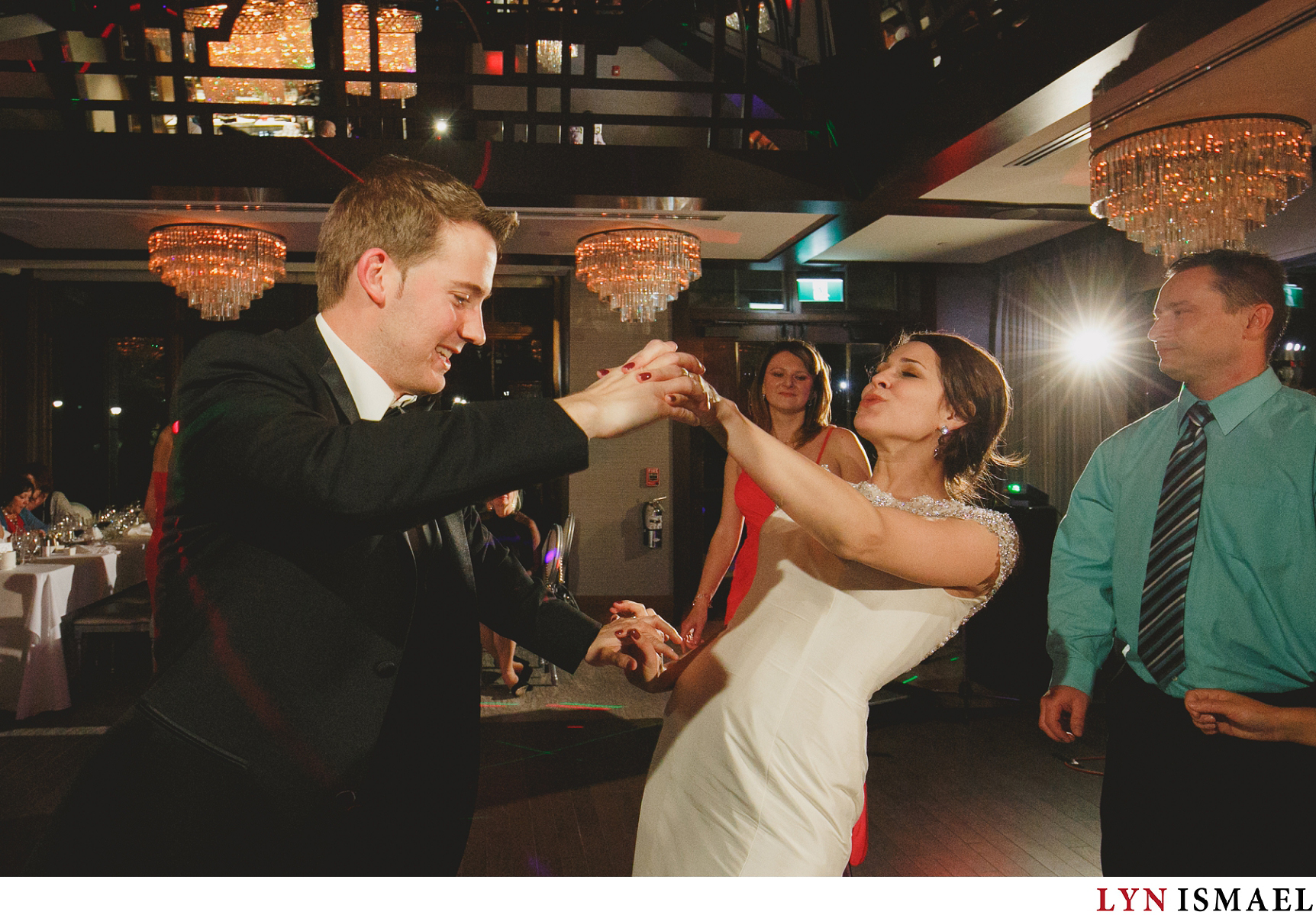 Bride and groom celebrates with their wedding guests as they dance on the dance floor at the Whistle Bear Golf Club wedding venue.