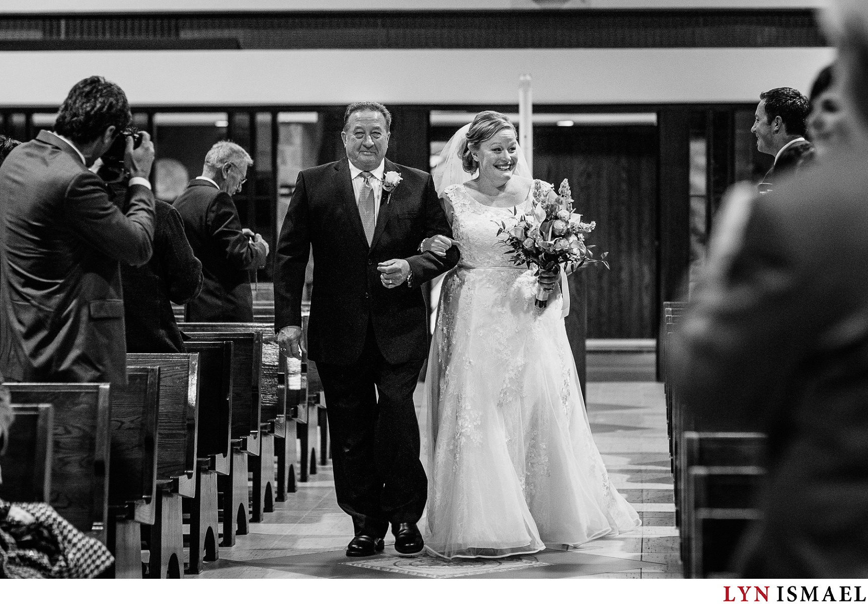 Bride walks down the aisle with her father at her side at St Michael Catholic Church in Waterloo, Ontario.