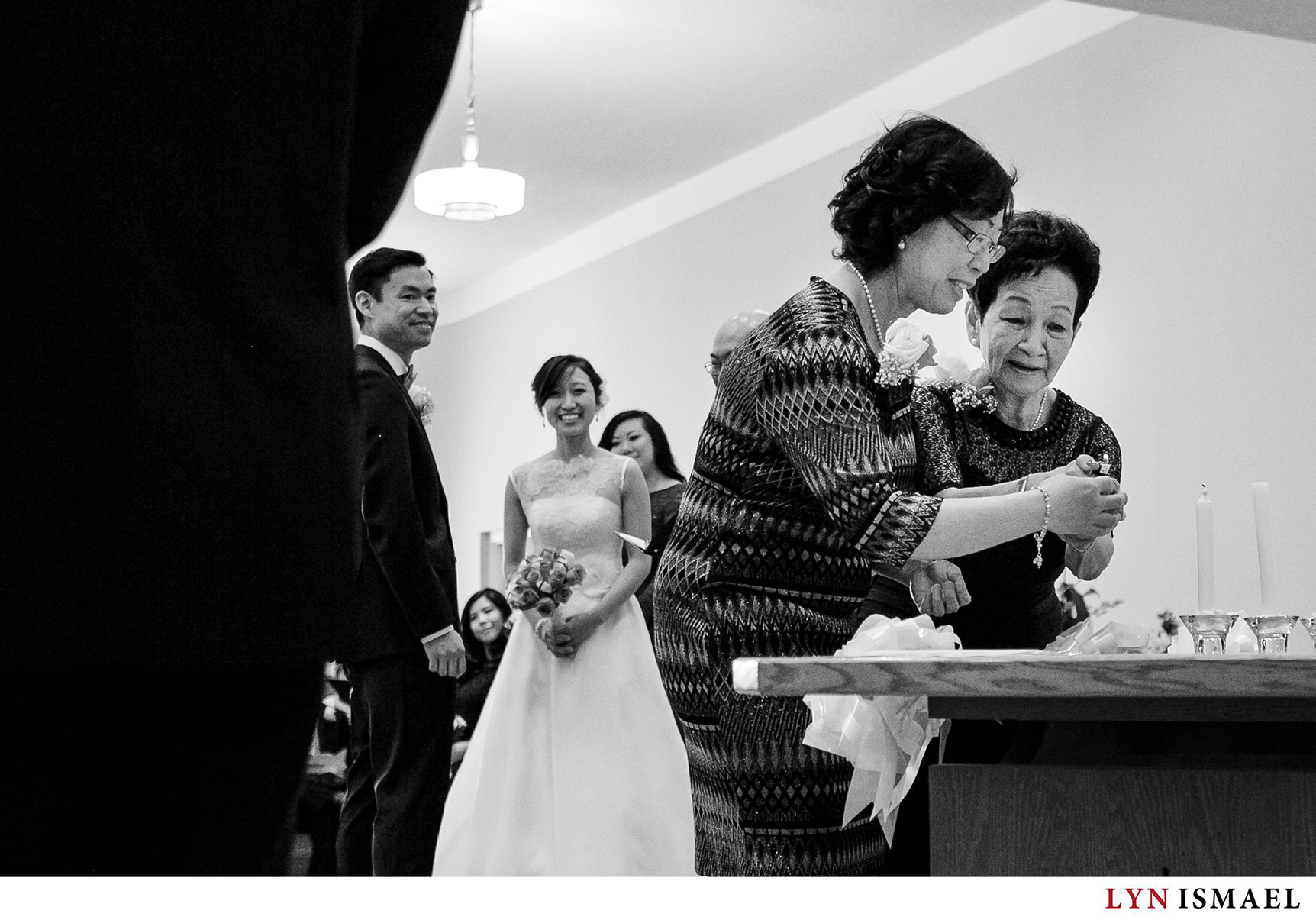 Groom's mother and the bride's grandmother light a candle at a wedding cereomy at the Chinese Gospel Church in Scarborough, Ontario.