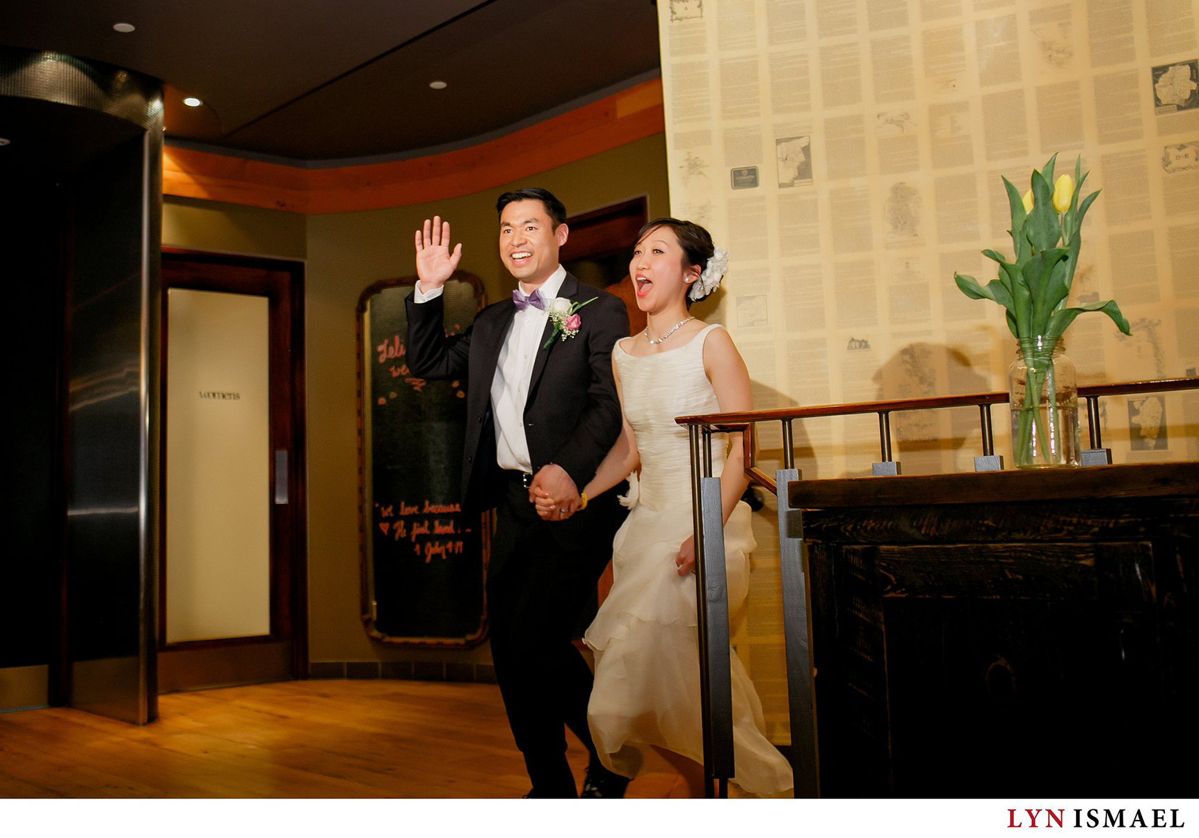 Bride and groom enters the reception area at Reds Wine Tavern in Toronto, Ontario.