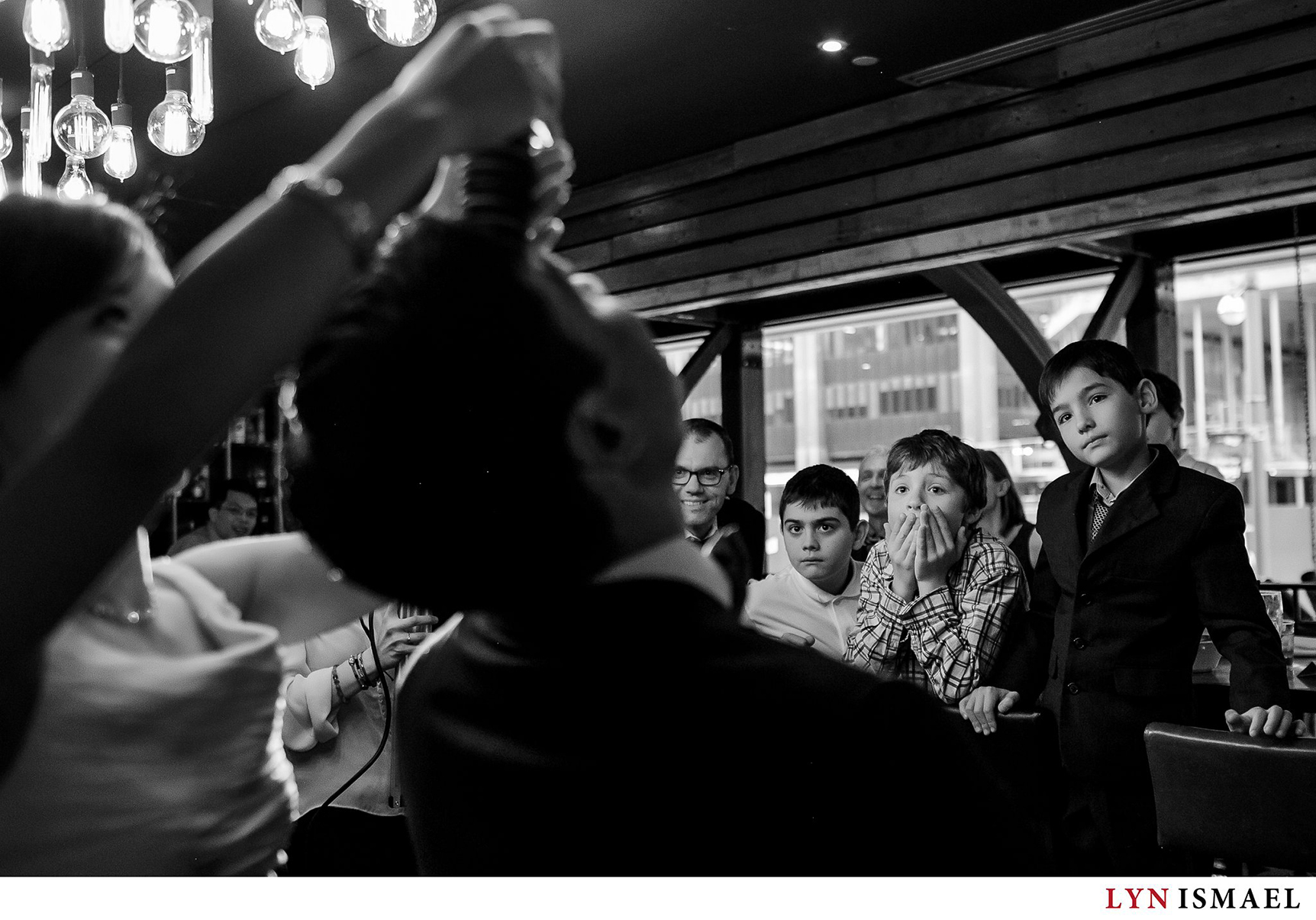 Little boys marvel at the stack of Oreos on the groom's forehead at a wedding in Toronto's Reds Wine Tavern.
