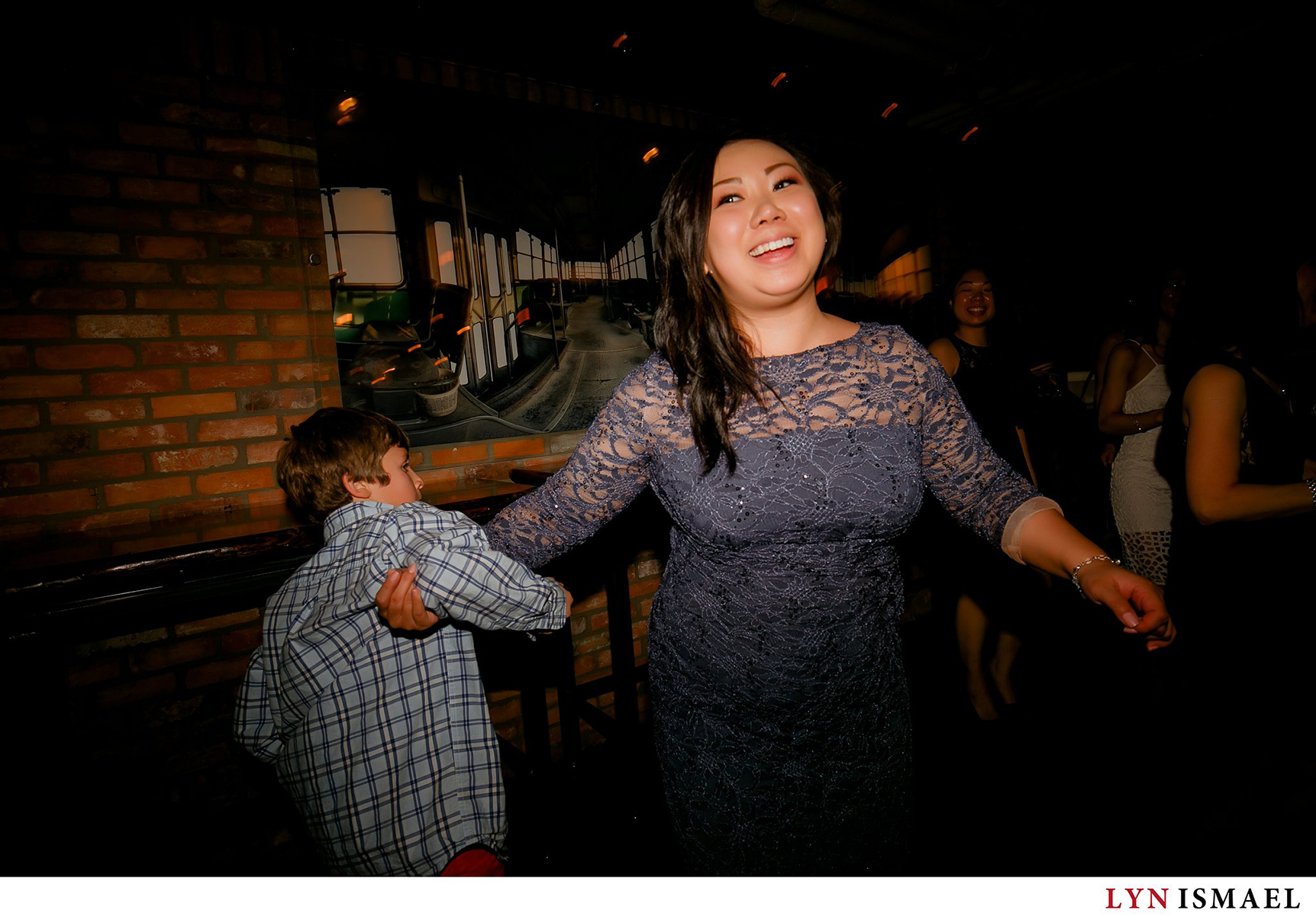 Bridesmaid dancing with a little guests at an urban wedding venue in Toronto.