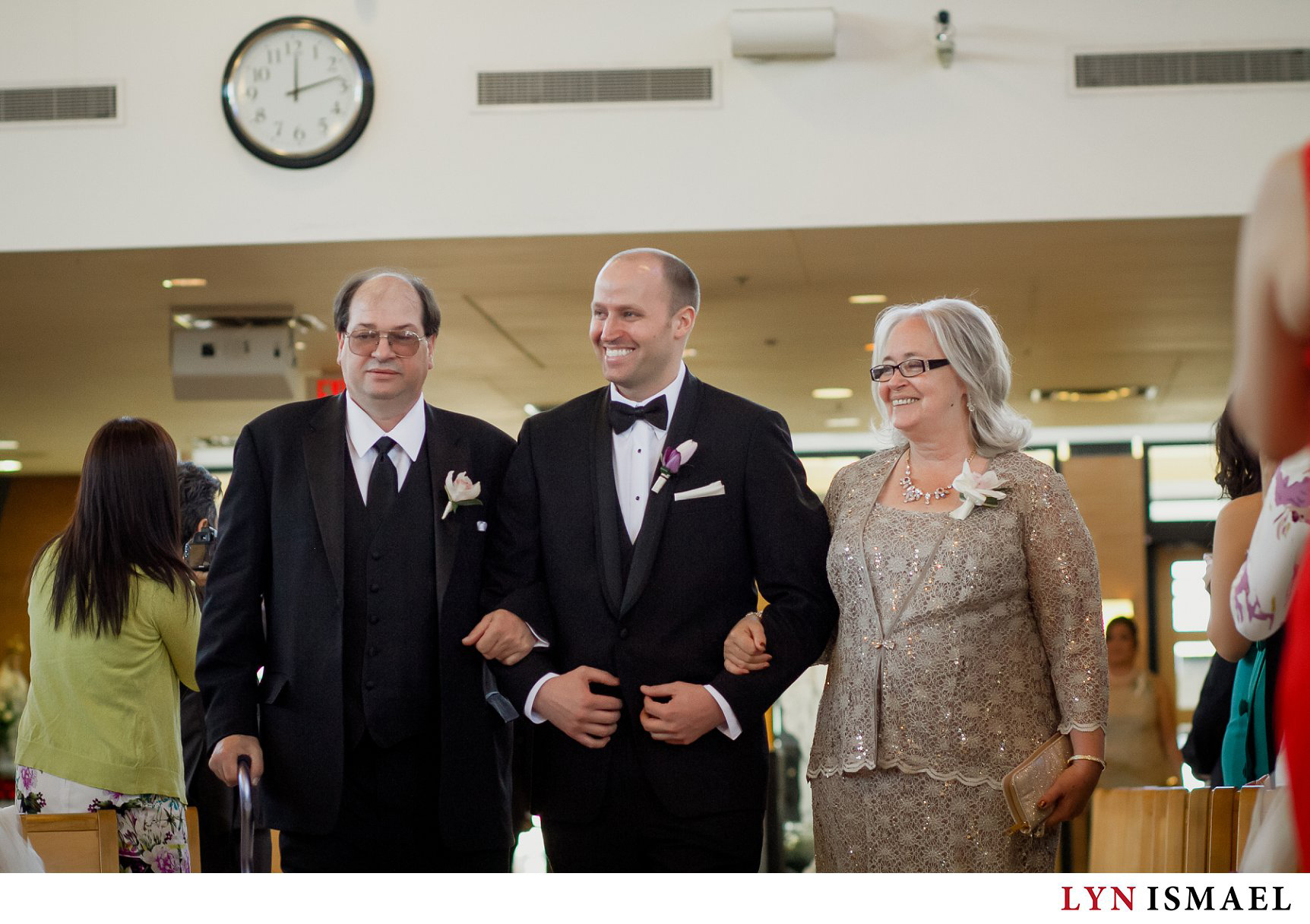 Father of the bride walks down the aisle with his parents