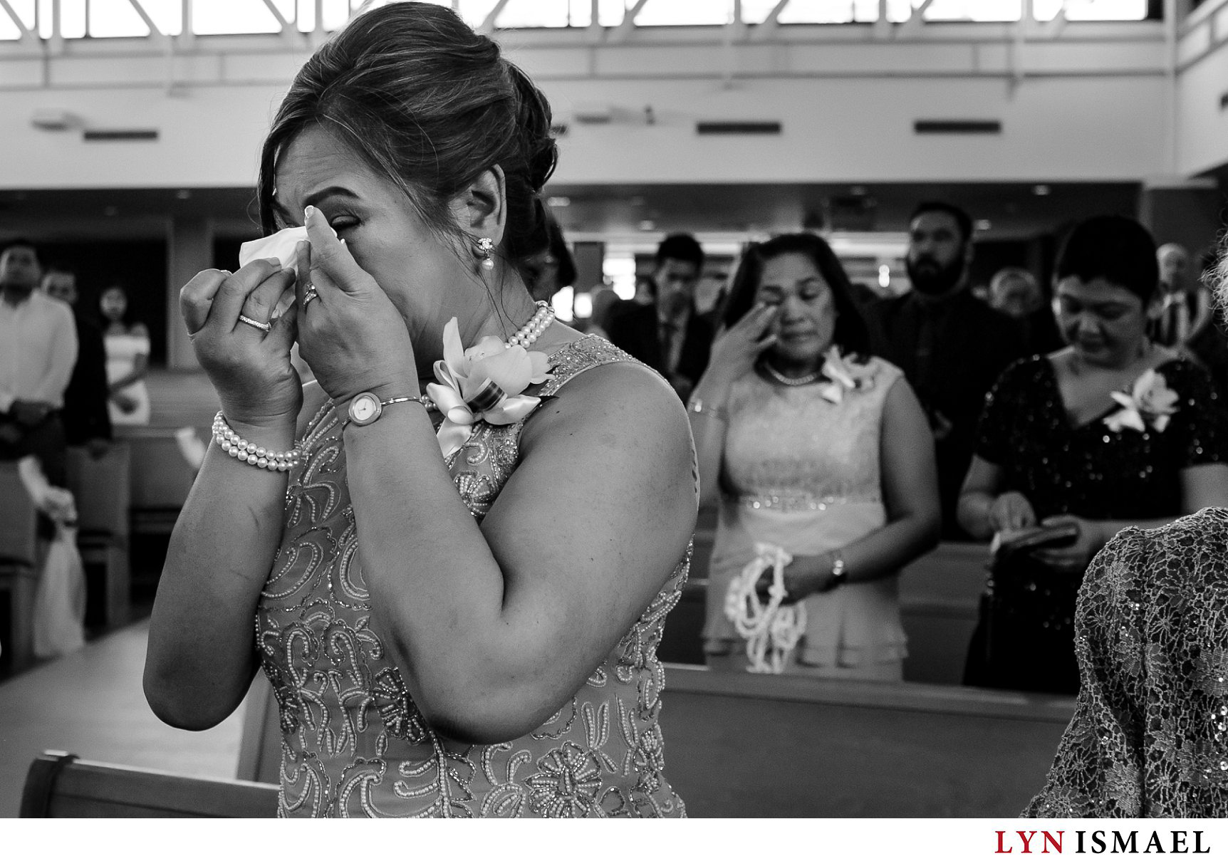 Mother of the bride cries at a wedding at St Francis Xavier Church