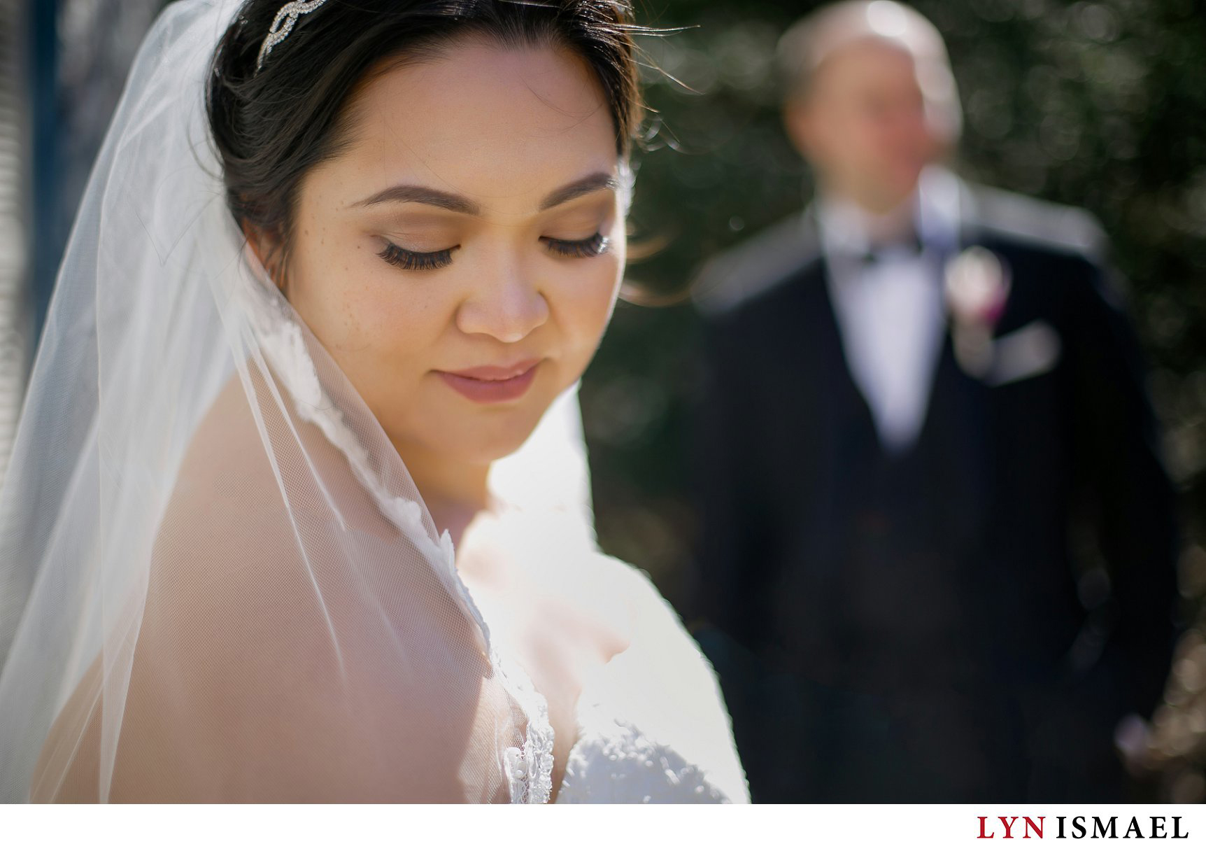 portrait of a bride with the groom in the background at Adamson Estate in Mississauga, Ontario.