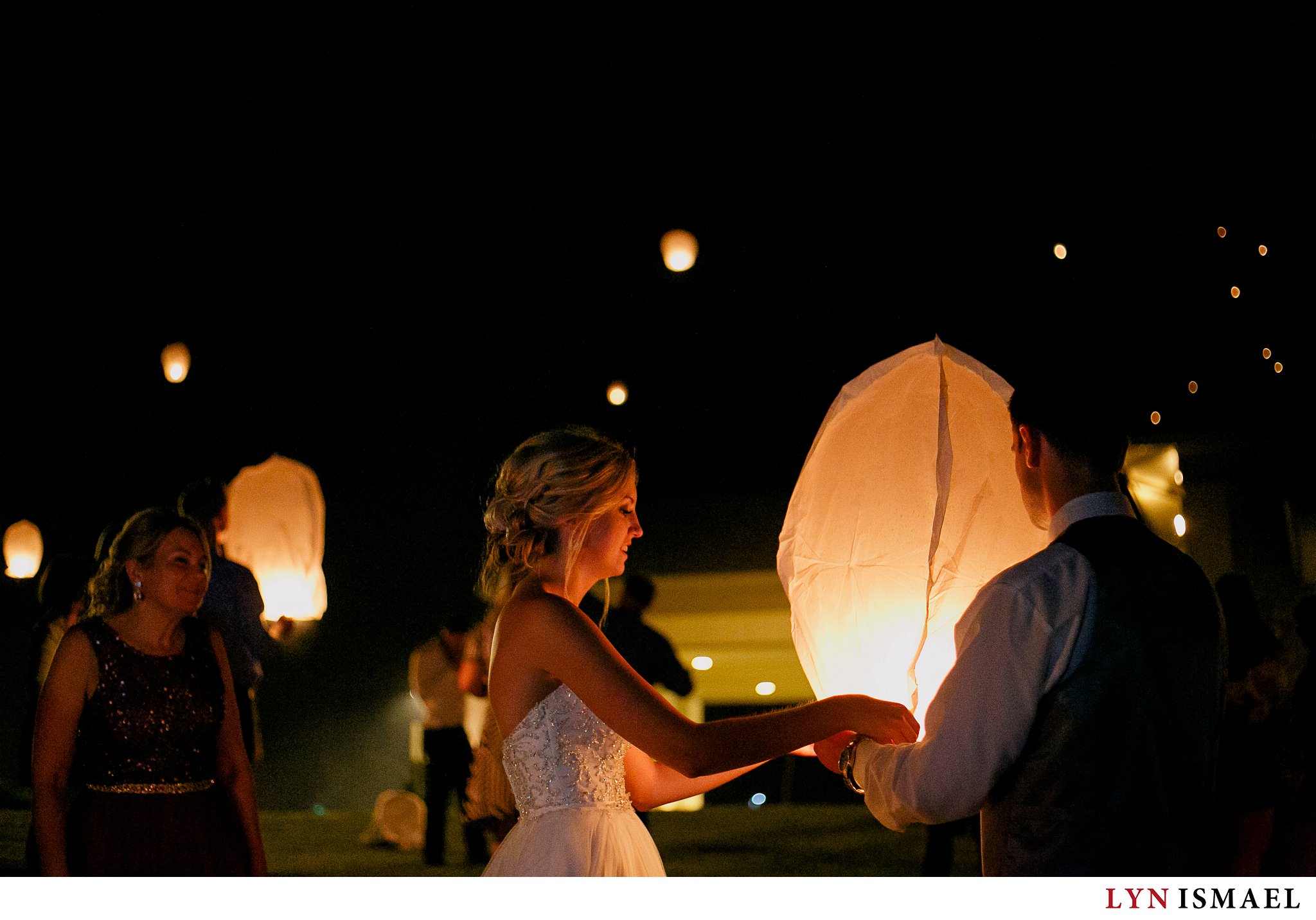Bride and groom prepares Chinese lanterns at their wedding at Alma Community Centre