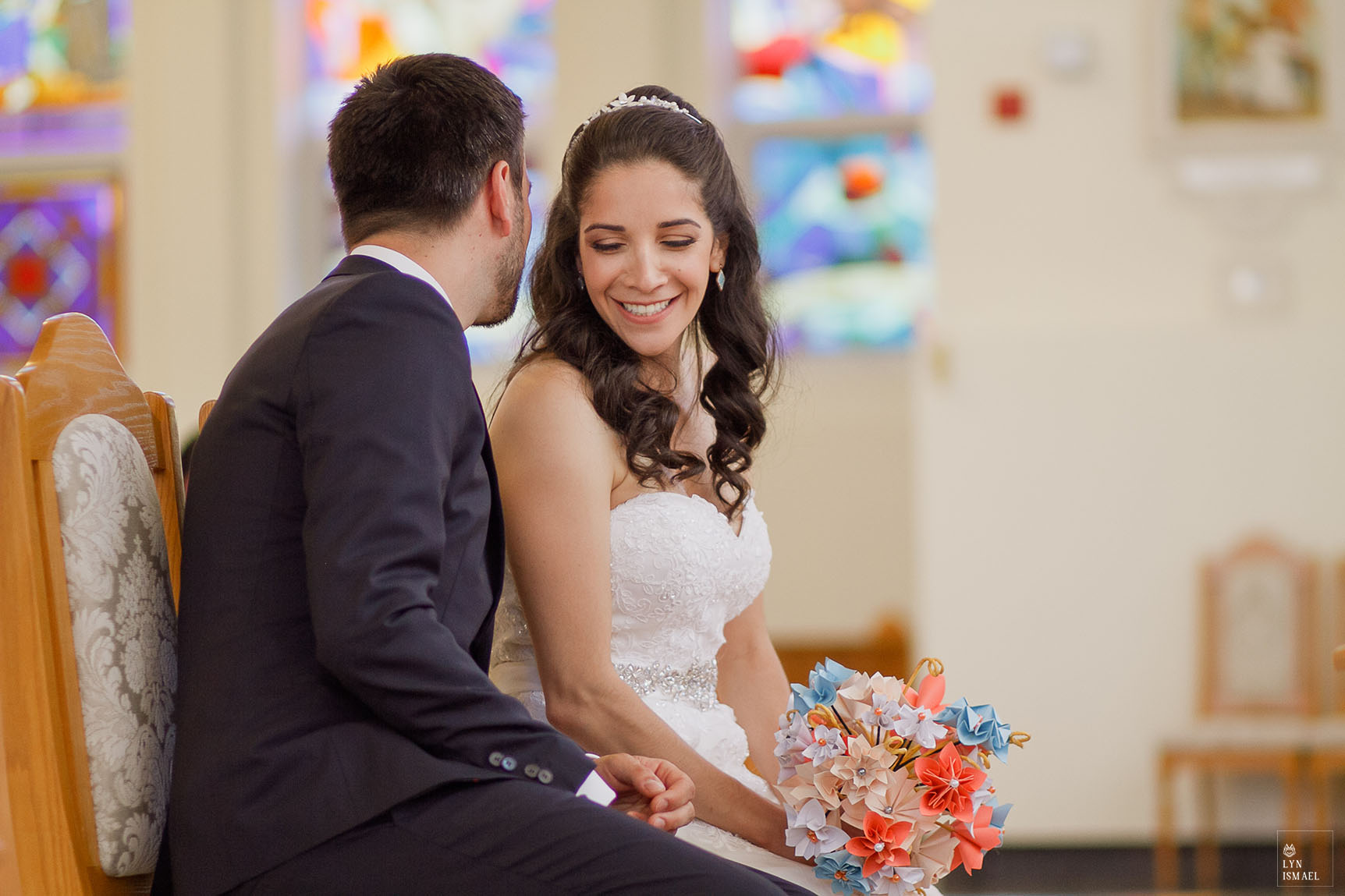 Groom whispers to the bride during their wedding ceremony at Croatian Centre Queen of Peace