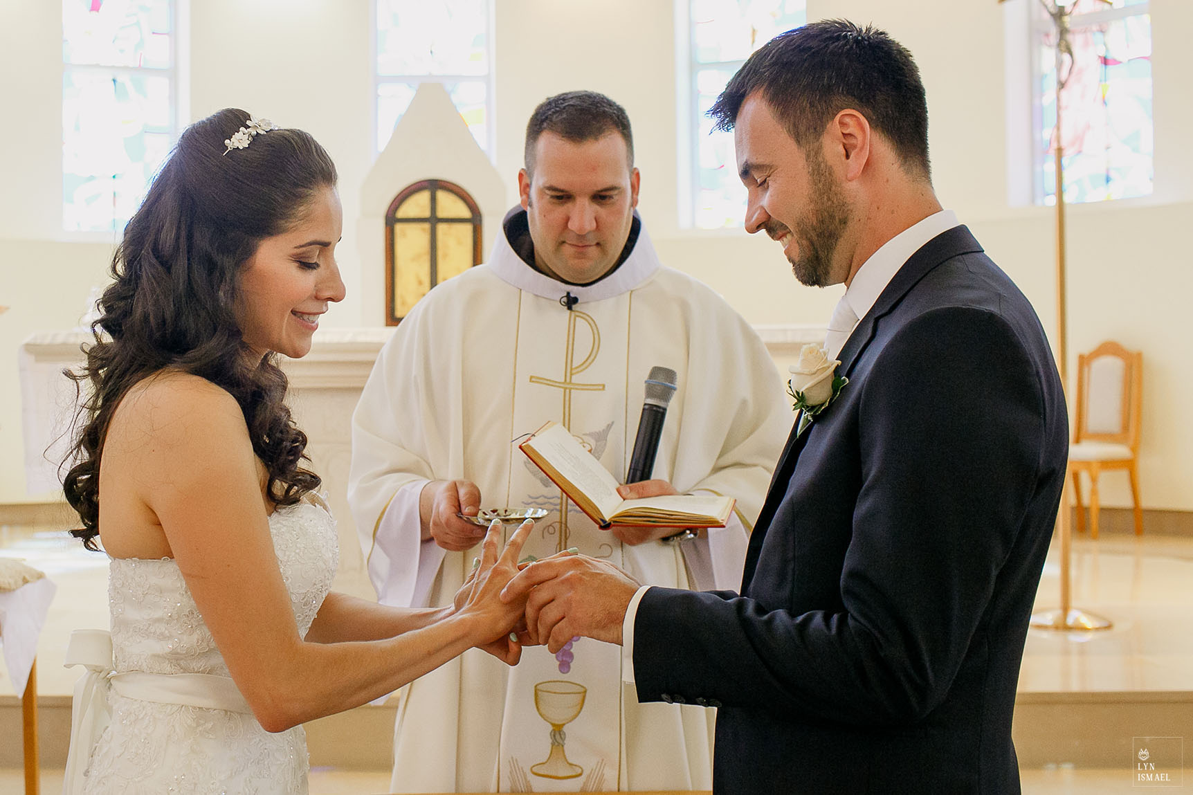 Bride and groom exchange rings at their wedding ceremony at the Croatian Centre Queen of Peace church