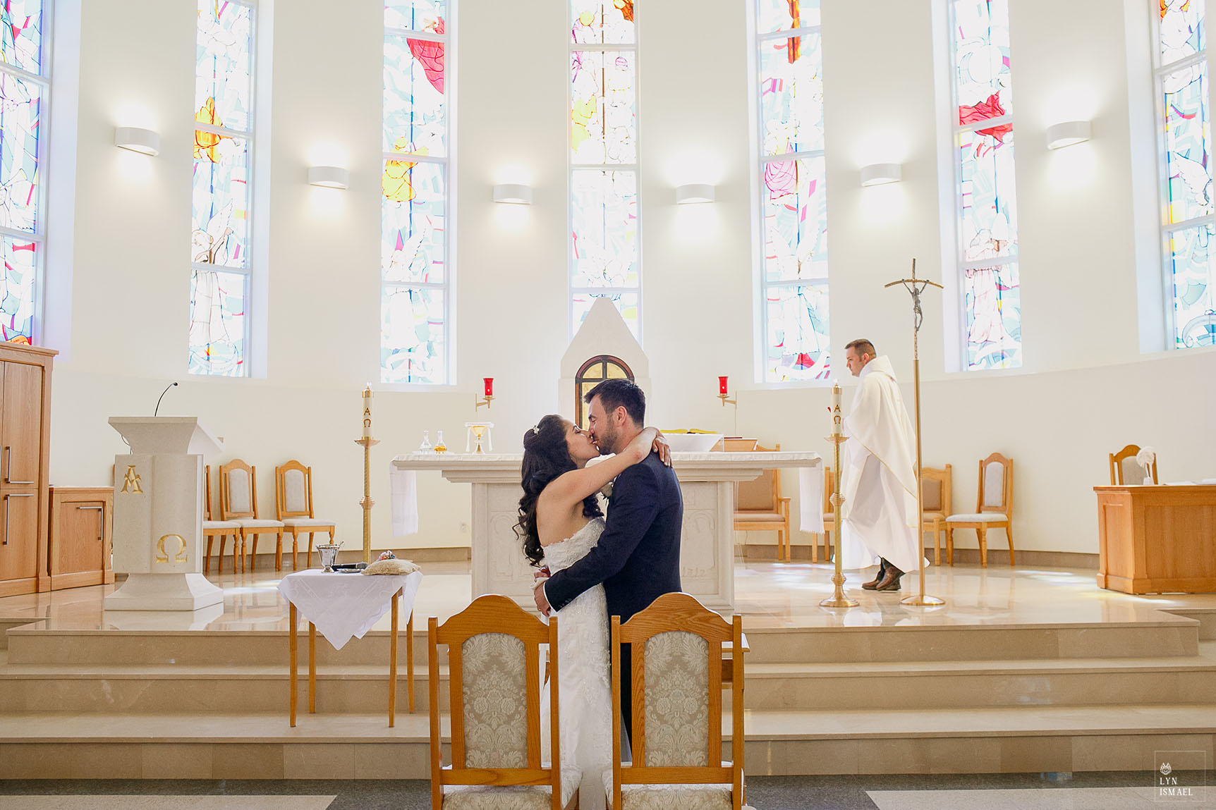 Bride and groom's first kiss at the Croatian Centre Queen of Peace church