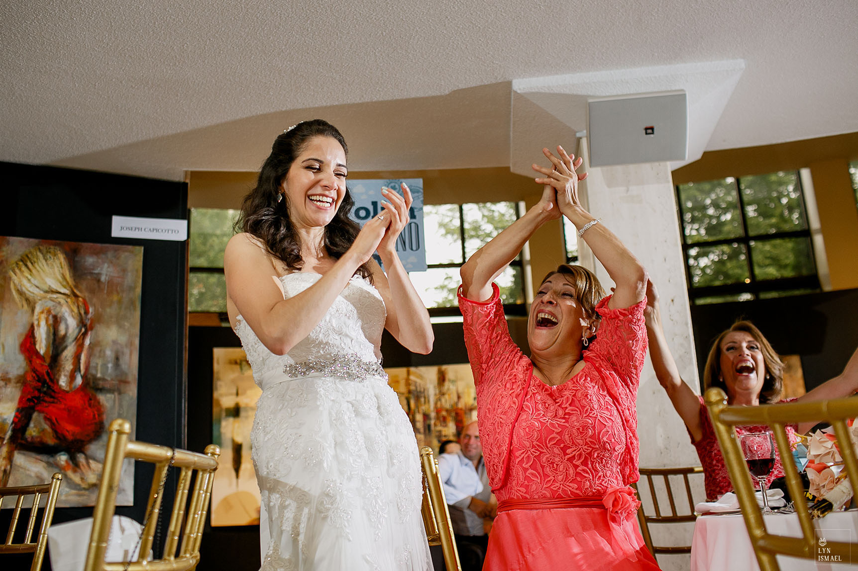Bride and her mother reacts to one of their friends speech at a wedding reception held at Columbus Event Centre