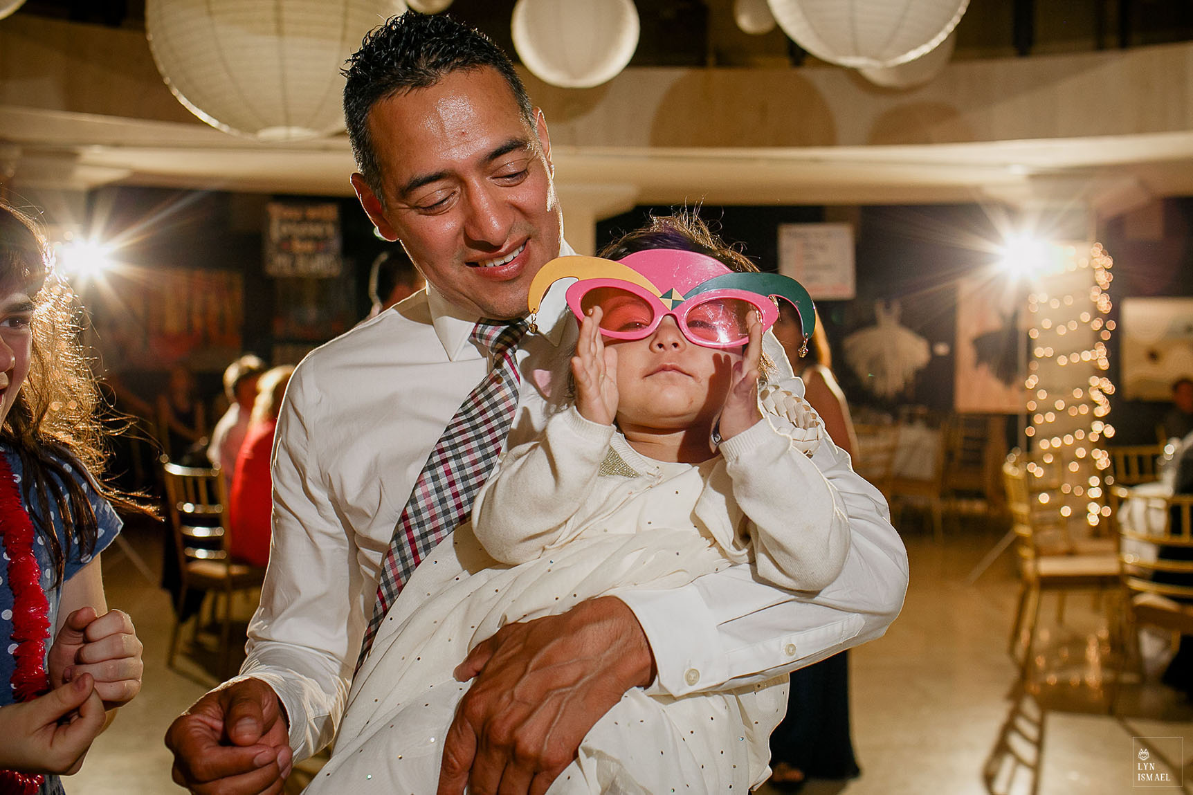 Little girl wears sunglasses at a wedding reception at Columbus Event Centre