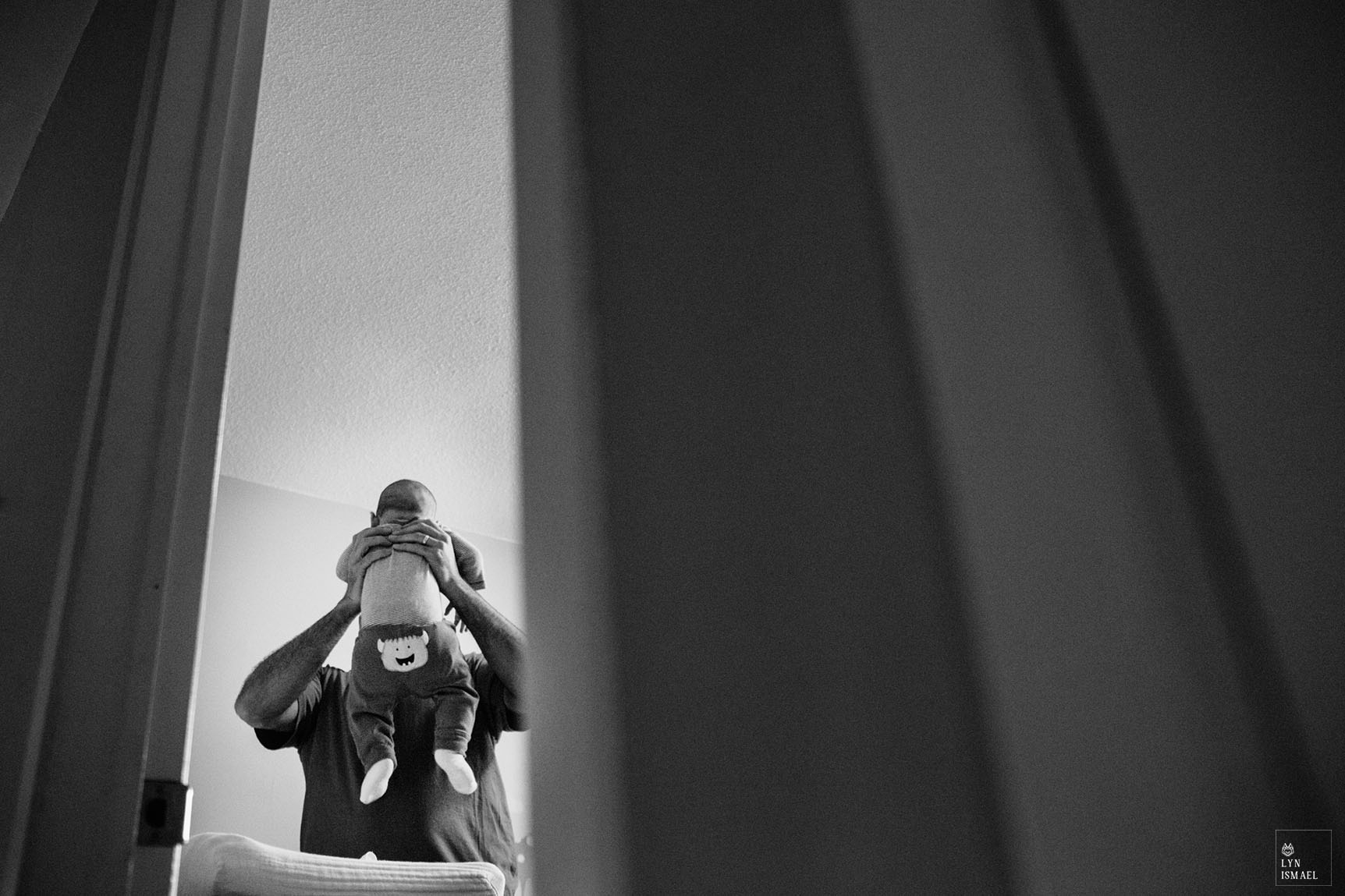 Young father changes his sons diaper as documented during a Day In The Life Session by Kitchener family documentary photographer