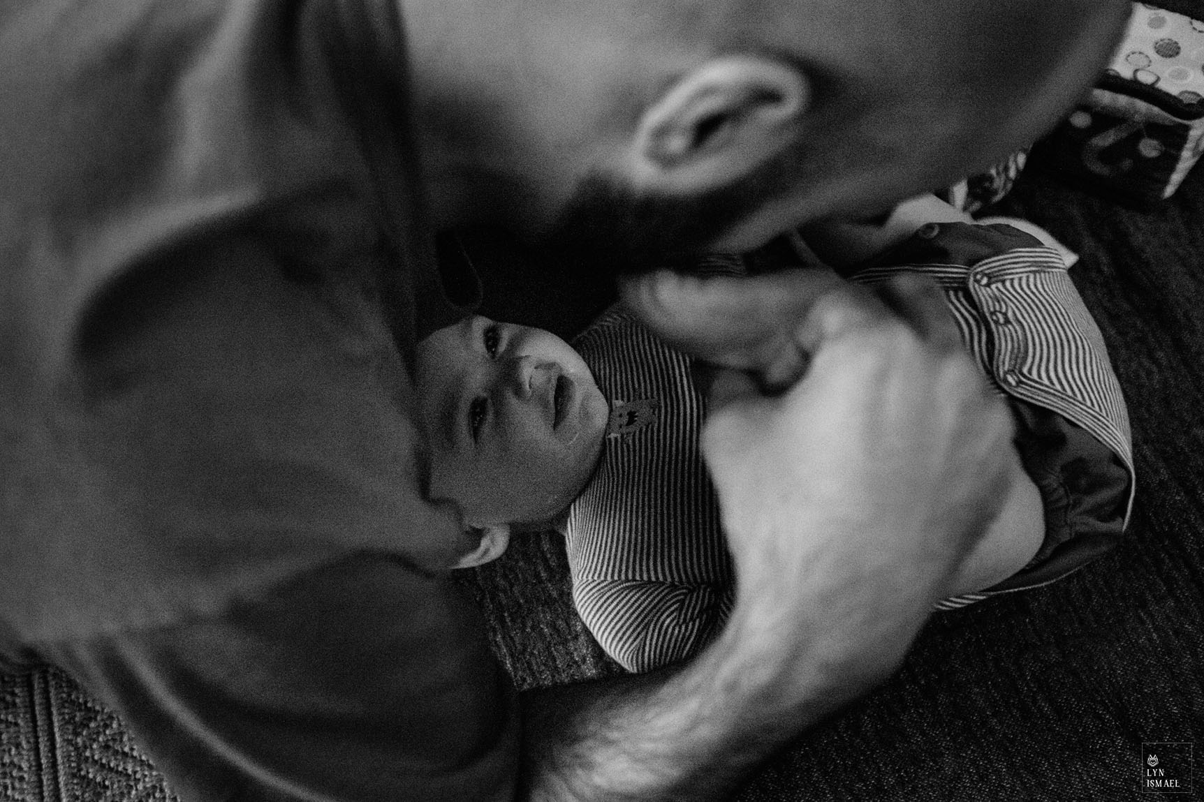a new father plays with his son at a Day In The Life session in Kitchener, Ontario