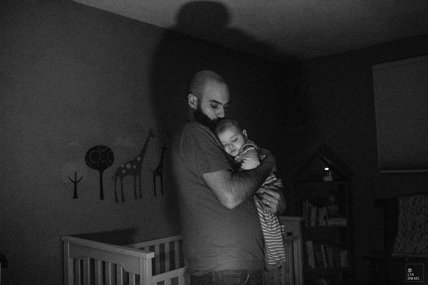 Kitchener family documentary photographer captures a father putting his son to sleep.
