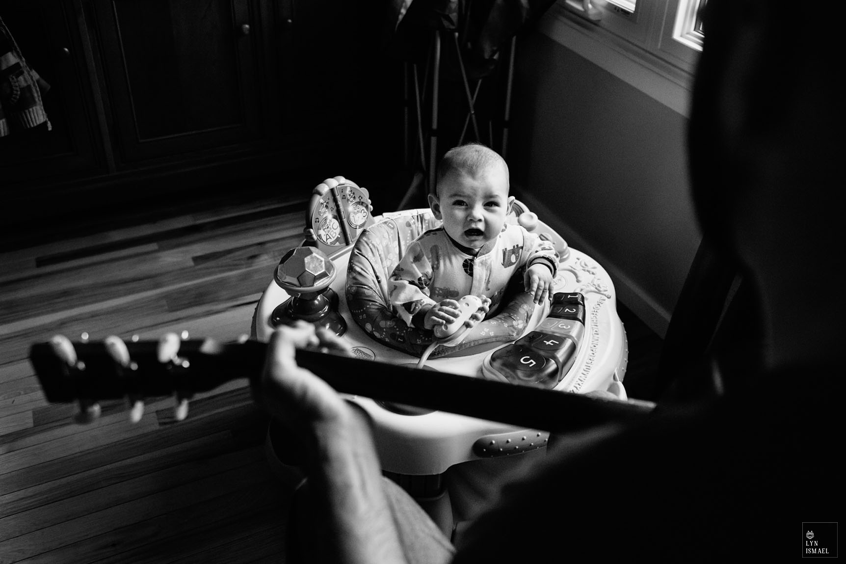 Kitchener family documentary photographer captures a kid crying as his father plays the guitar