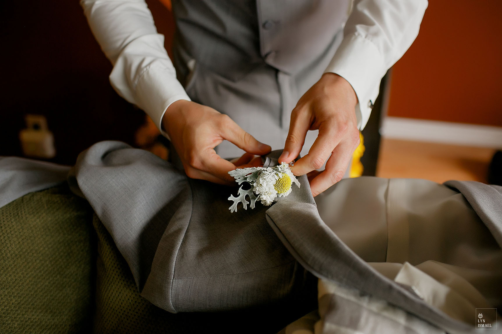 Groom pins his boutonniere