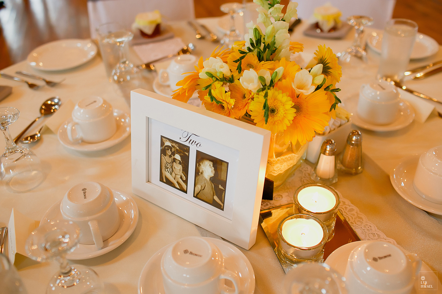Table numbers decor featuring their childhood photos at a Grey Silo wedding reception