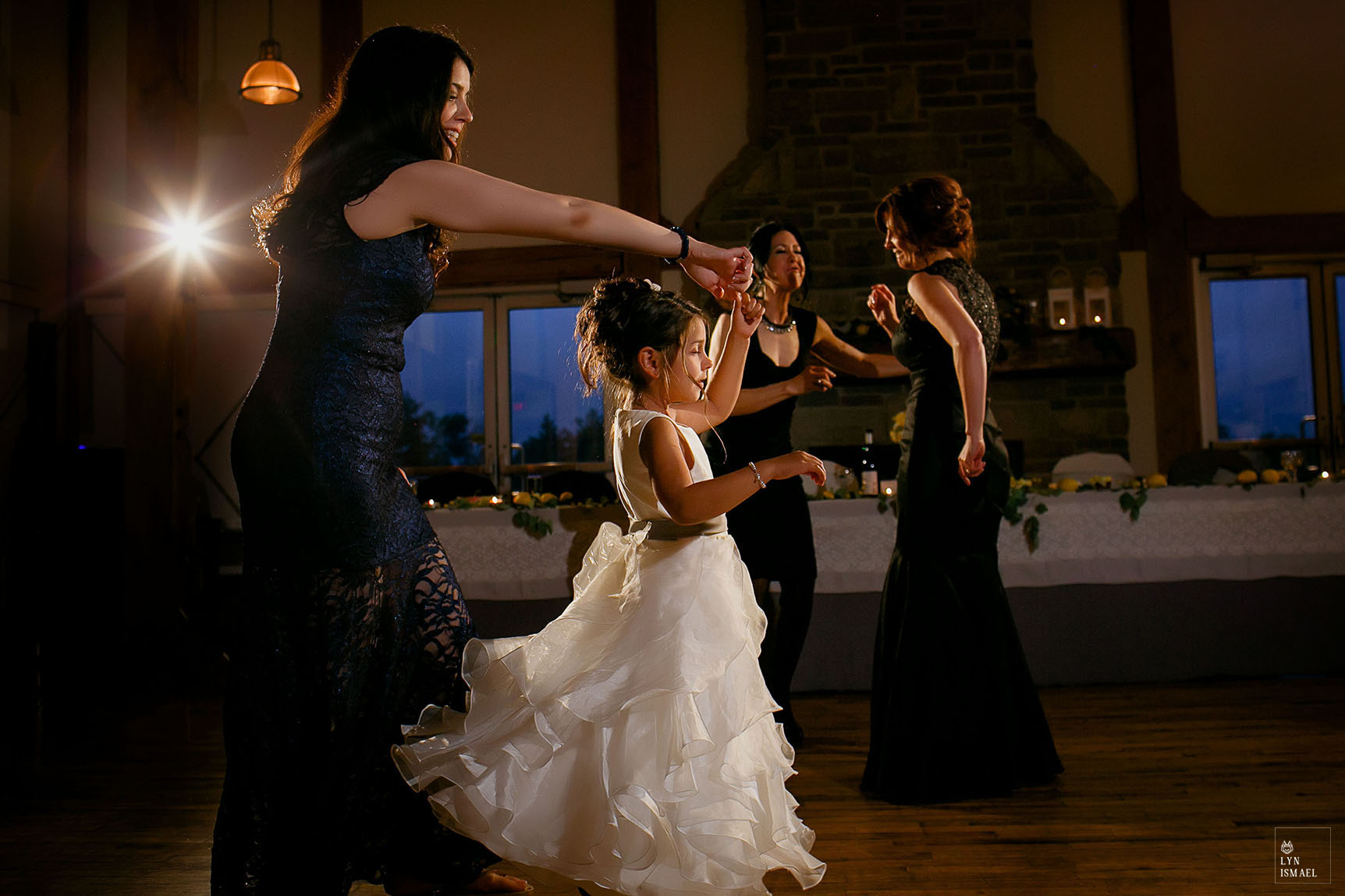 Flower girl dances with her mother at a wedding reception in Grey Silo