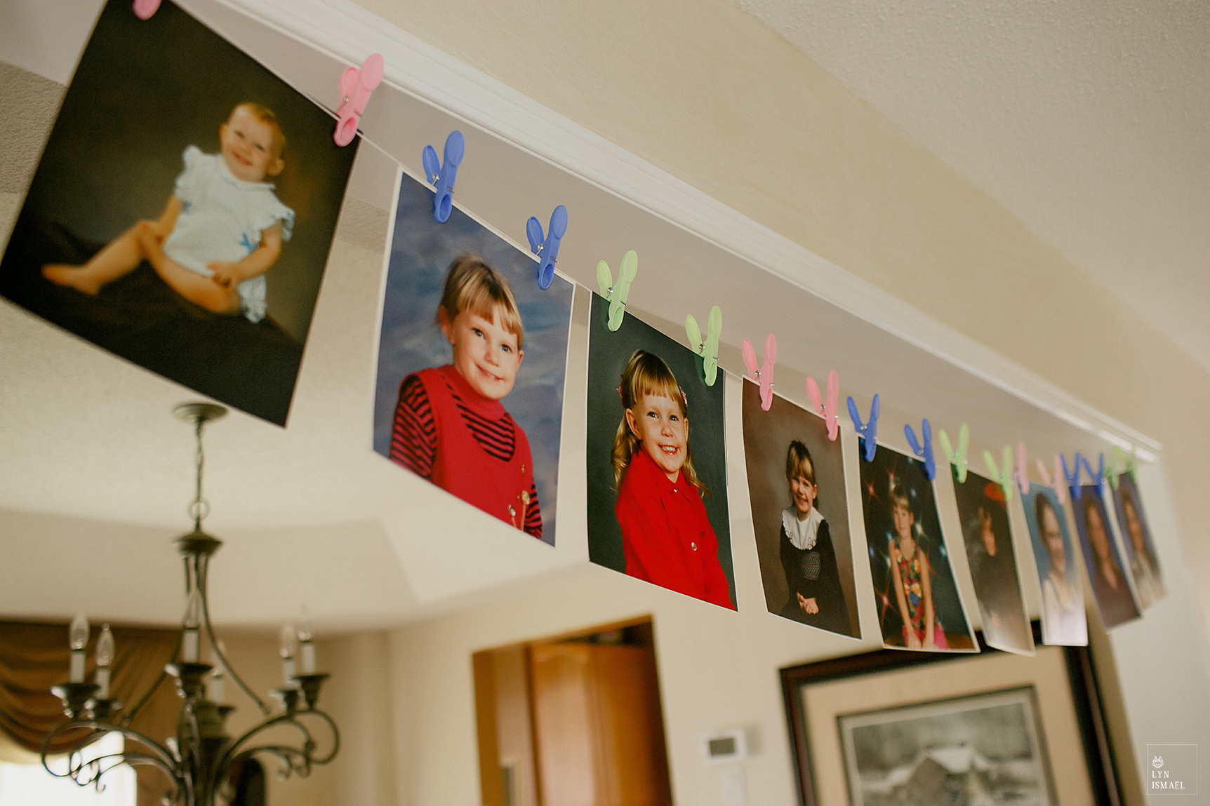 Photos of the bride growing up displayed in her parents' house.