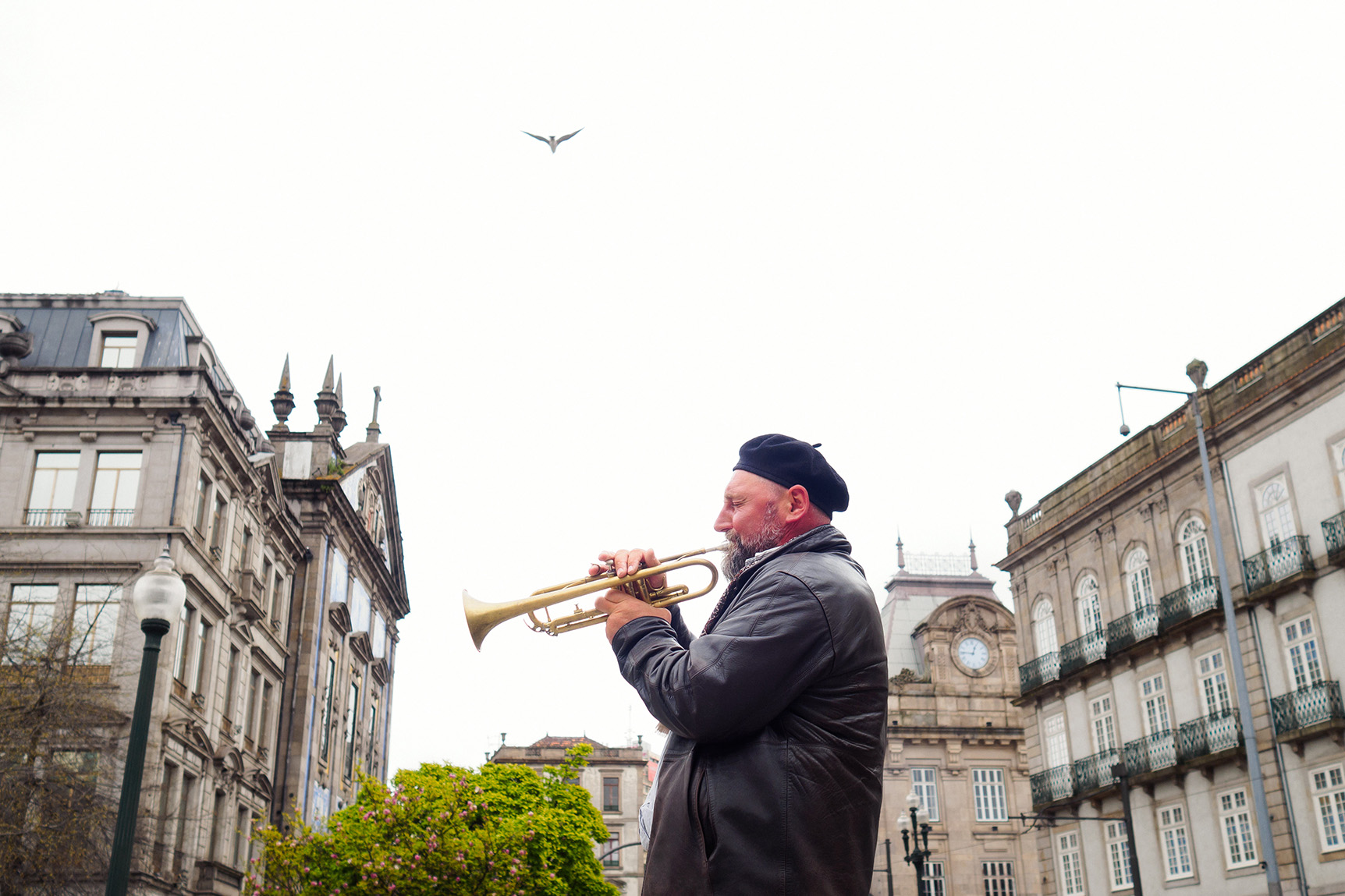 Musician playing the trumpet on Avenida dos Alidados in Porto