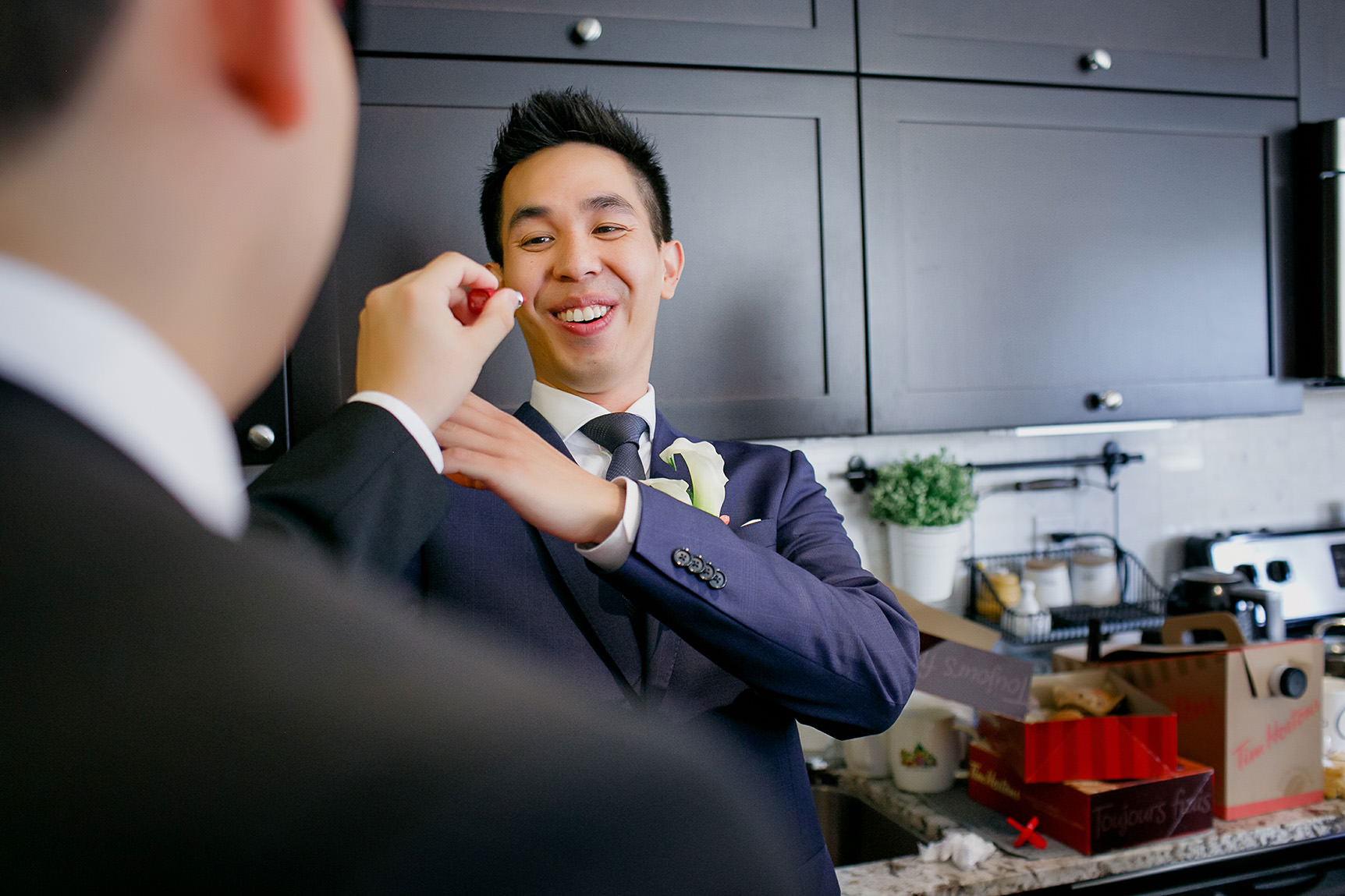 groomsman tries to put on lipstick at the groom