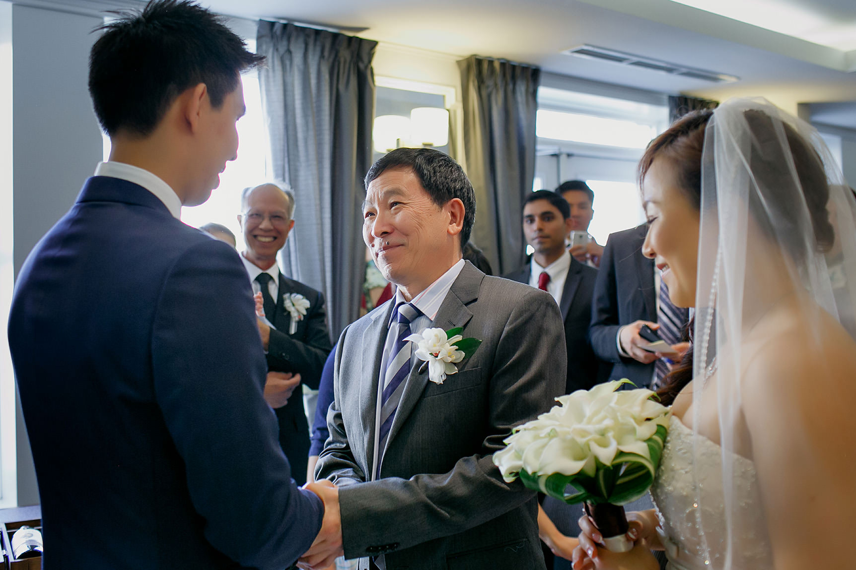 Bride's father shakes the groom's hands