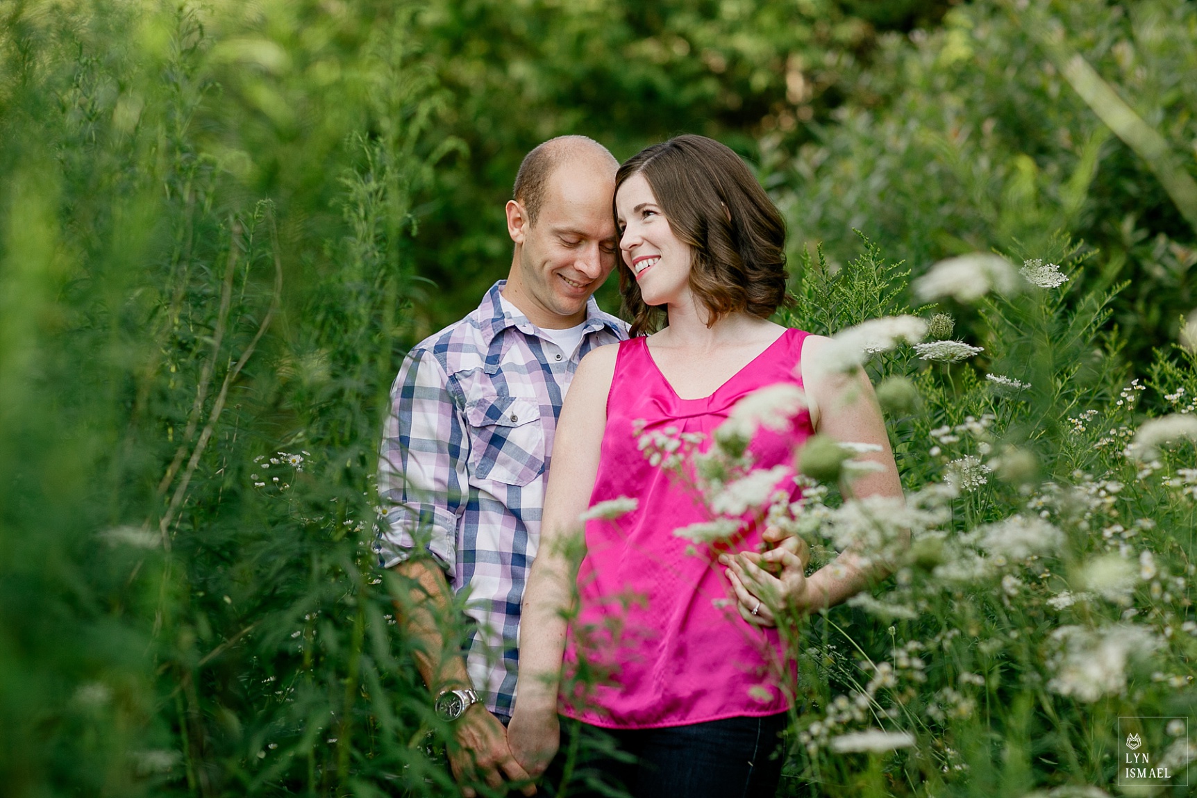 a couple poses for their Rockwood Conservation Area engagement session in the middle of a field of wildflowers.