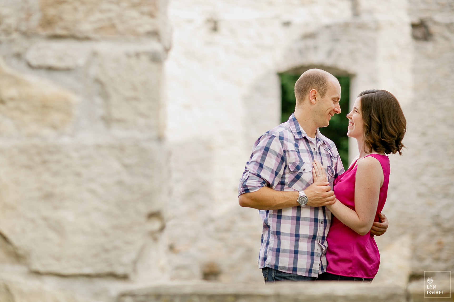using windows and doorways of the old mill ruin to frame engagement portraits at Rockwood Conservation Area