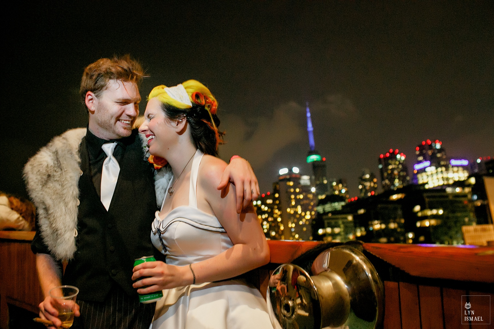Bride and groom portrait at night with the Toronto skyline in the background.