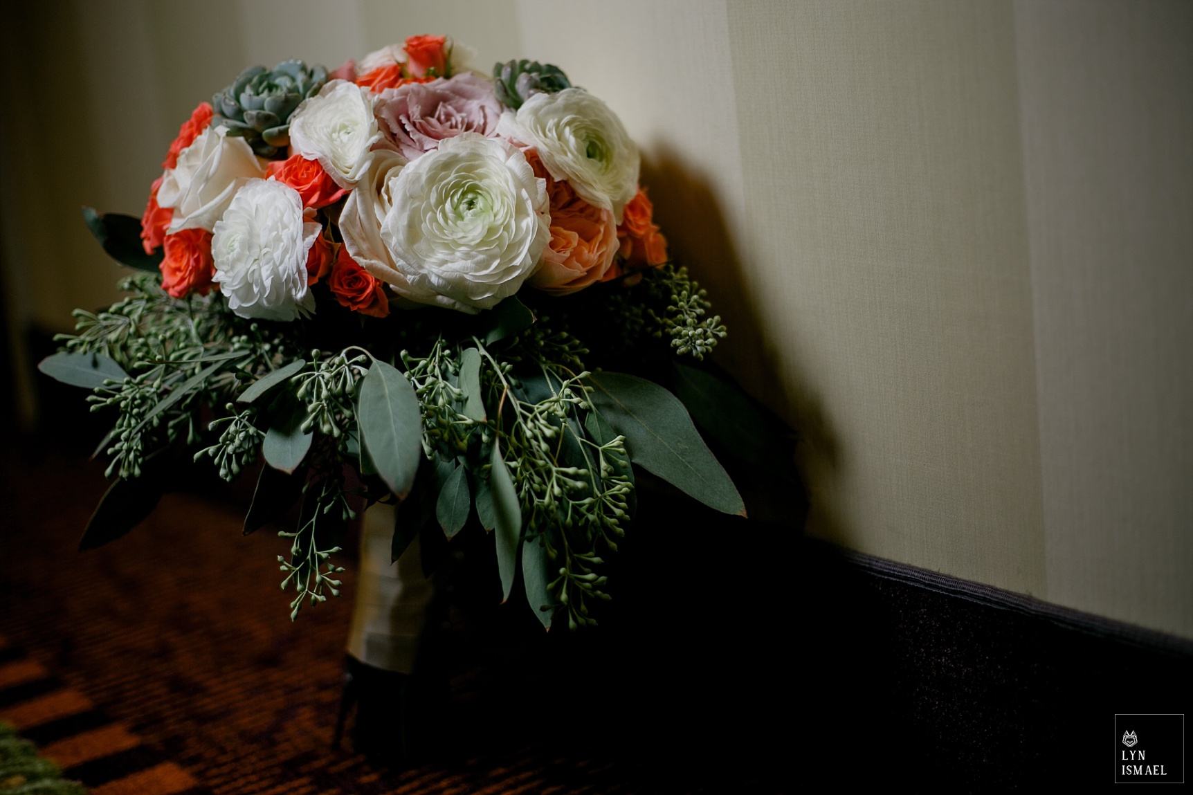 White ranunculus with coral roses as wedding bouquet at a wedding in Cambridge, Ontario
