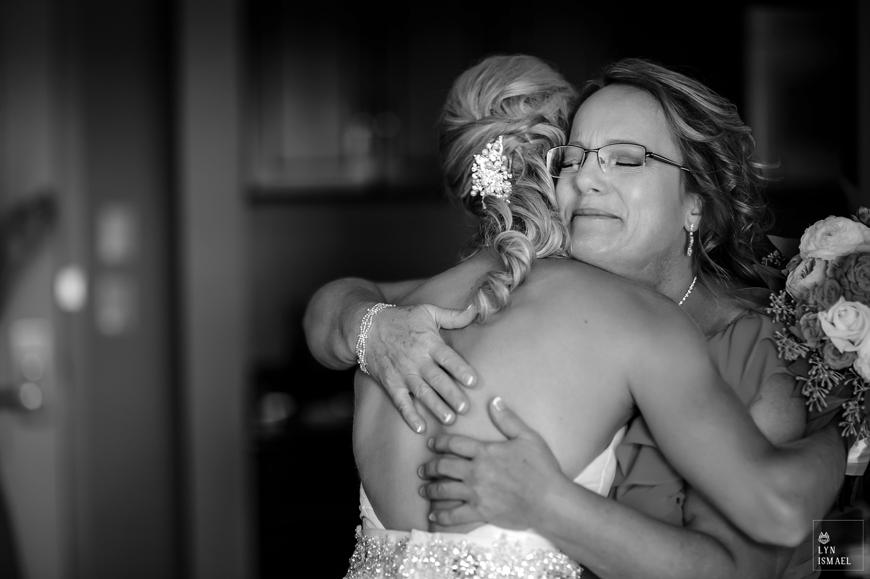 Mother of the bride sees the bride for the first time fully dresses in her wedding gown.