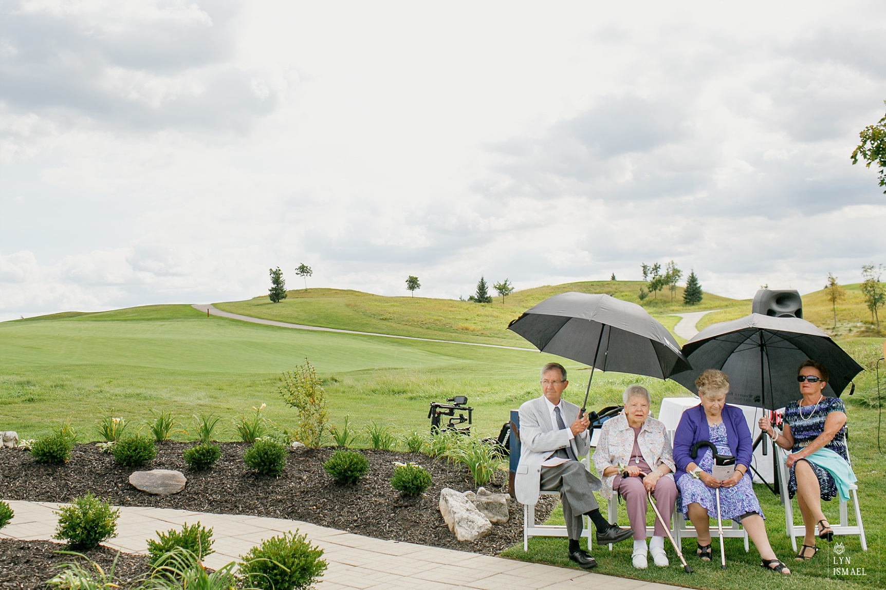 Grandparents of the bride and groom wait for the wedding ceremony to start at Whistle Bear Golf Course, an outdoor wedding venue in Waterloo region.